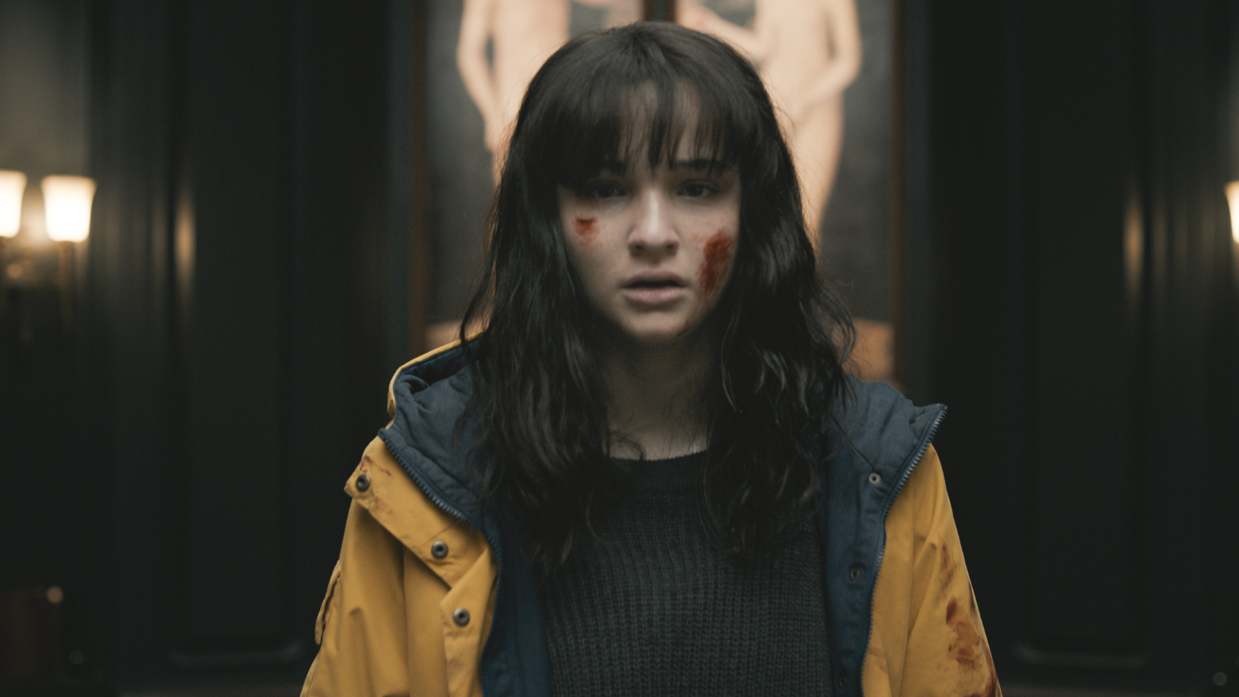 A troubled and bloodied Lisa Vicari with mouth agape in Dark