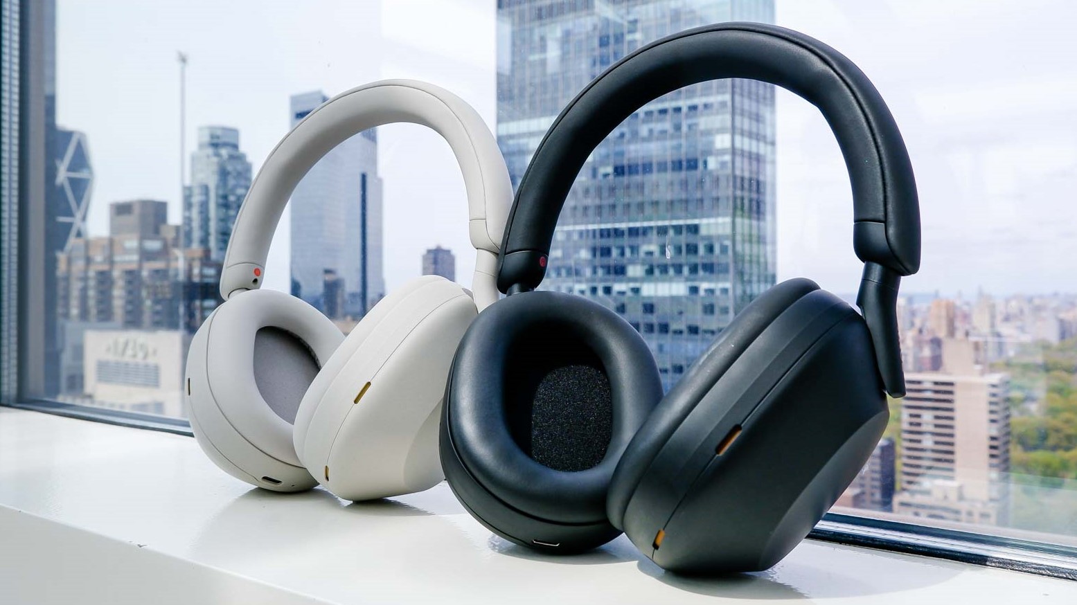 Sony WH-1000XM5 in black and silver placed by a window