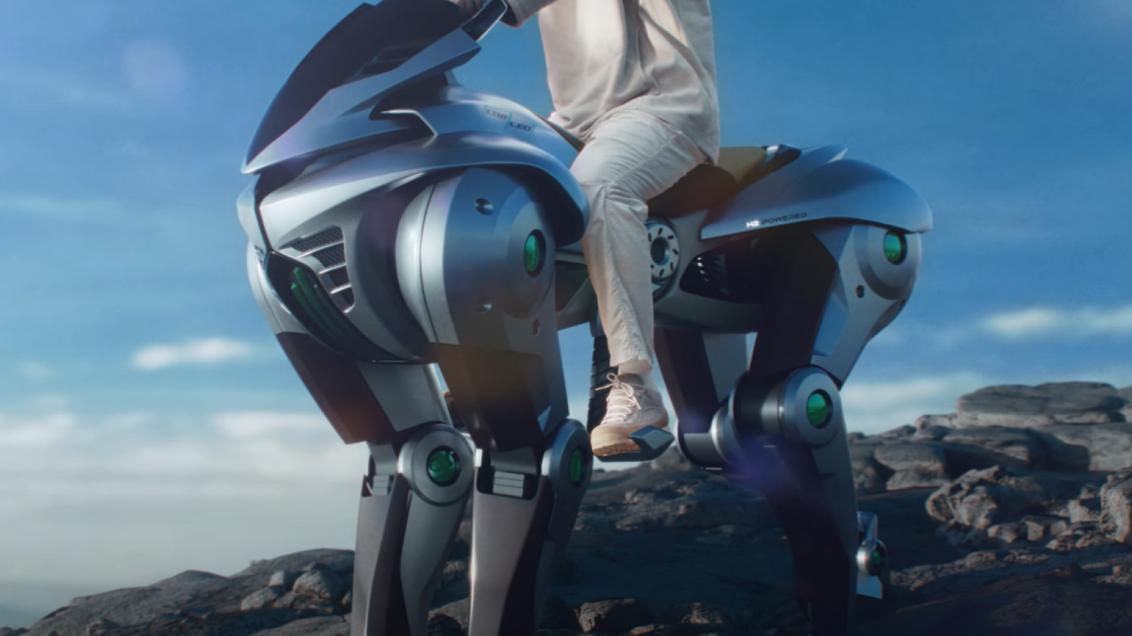 Digital rendition of a four legged robot with a human on its back.