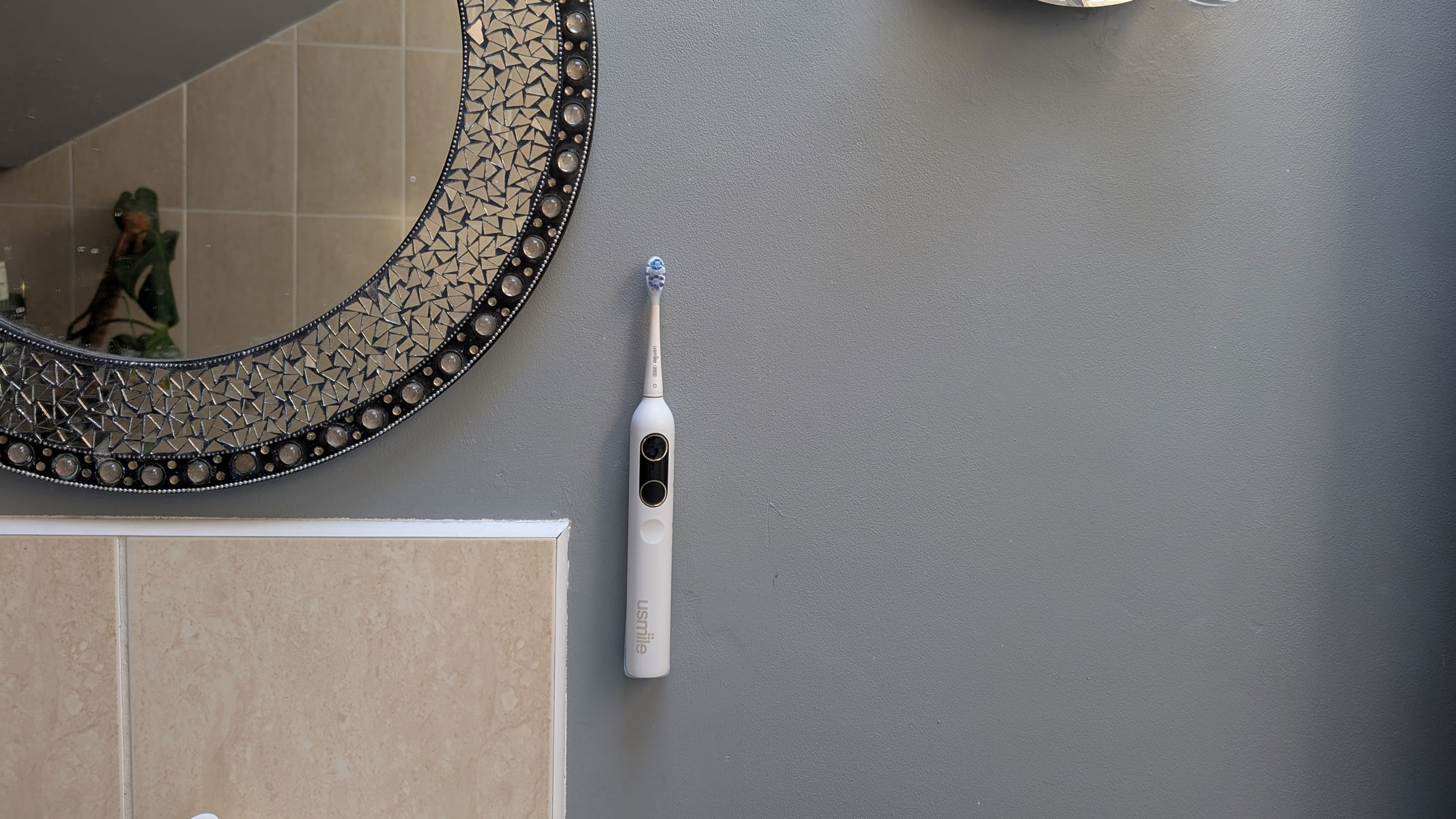 usmile Y10 PRO electric toothbrush attached to the wall