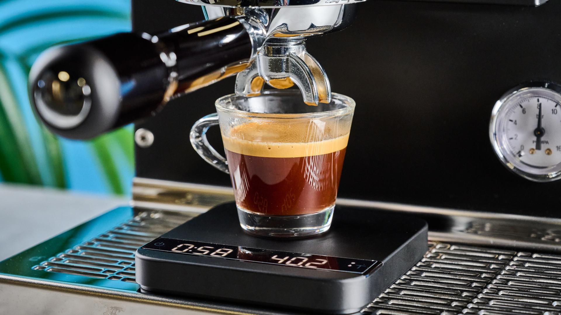 The Diletta Mio espresso machine with a shot of espresso on the drip tray