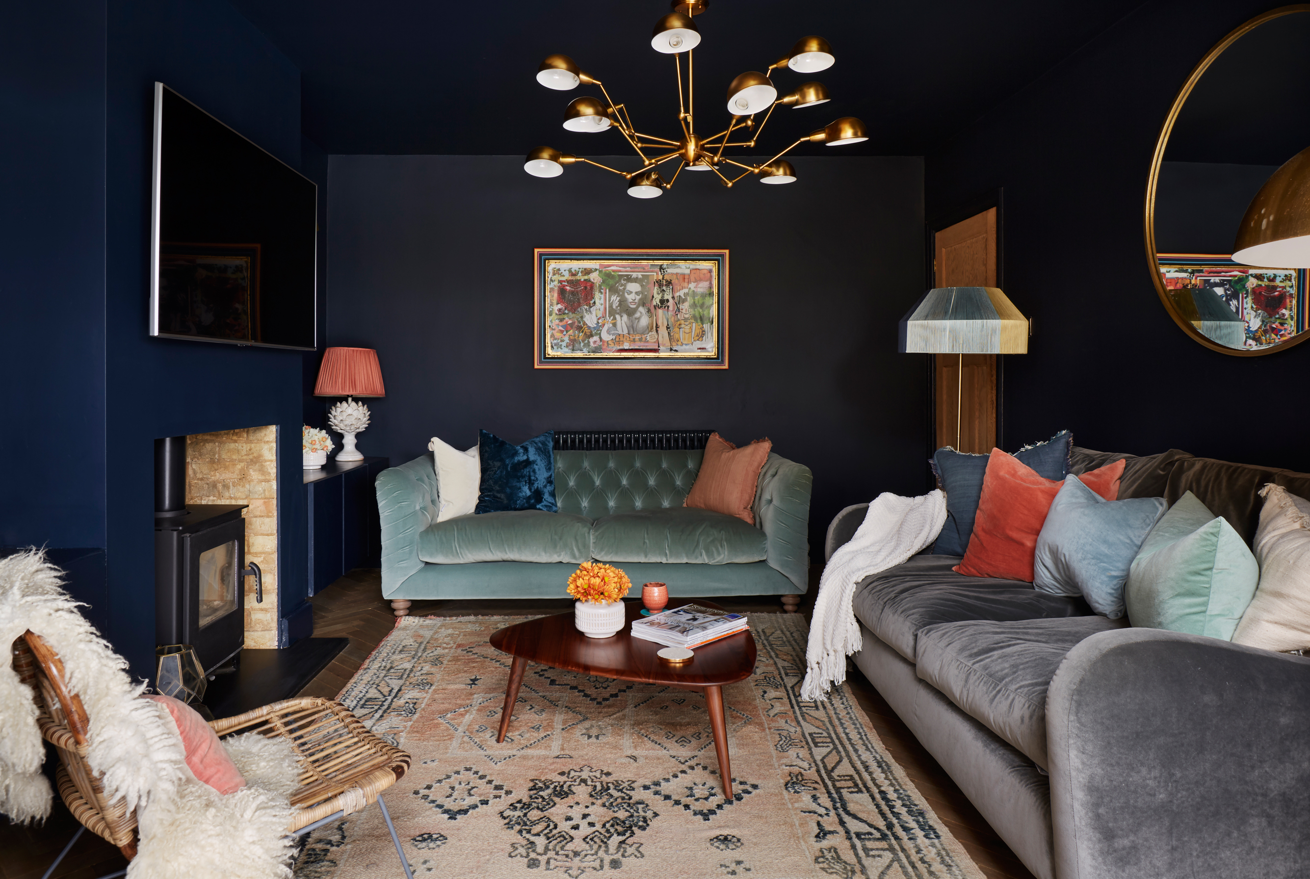 Tv above fireplace in dark painted living room snug