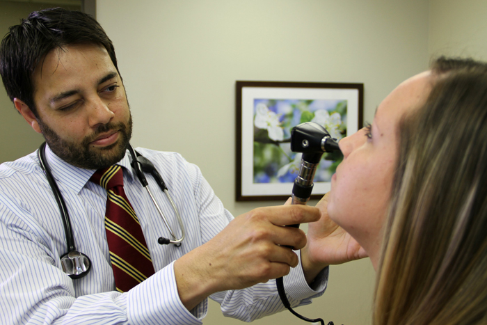 Dr. Nabeel Farooqui examines an allergy patient at The Ohio State University Wexner Medical Center. Farooqui says many of his patients buy into common allergy myths that can actually make their symptoms worse. Assuming anti-allergy pillows are healthier than feather pillows is a common misconception, as is the idea of owning "hypoallergenic" pets which, Farooqui says, really don't exist.