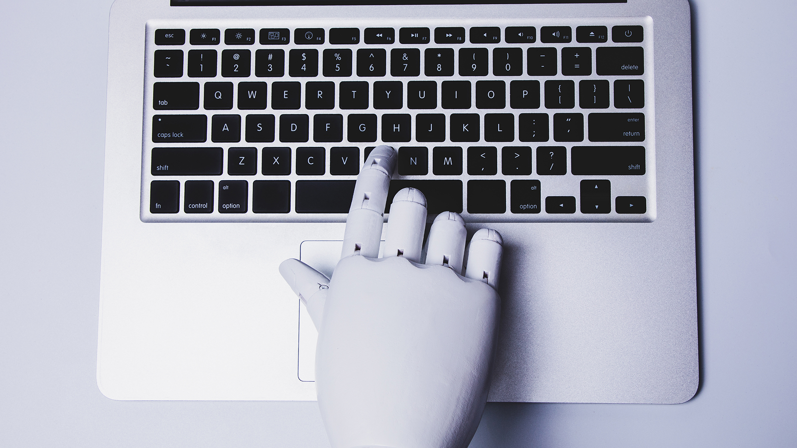 Robotic hand using laptop.
