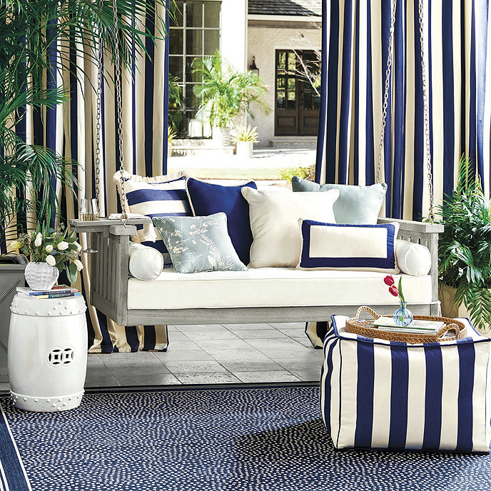porch with striped porch swing