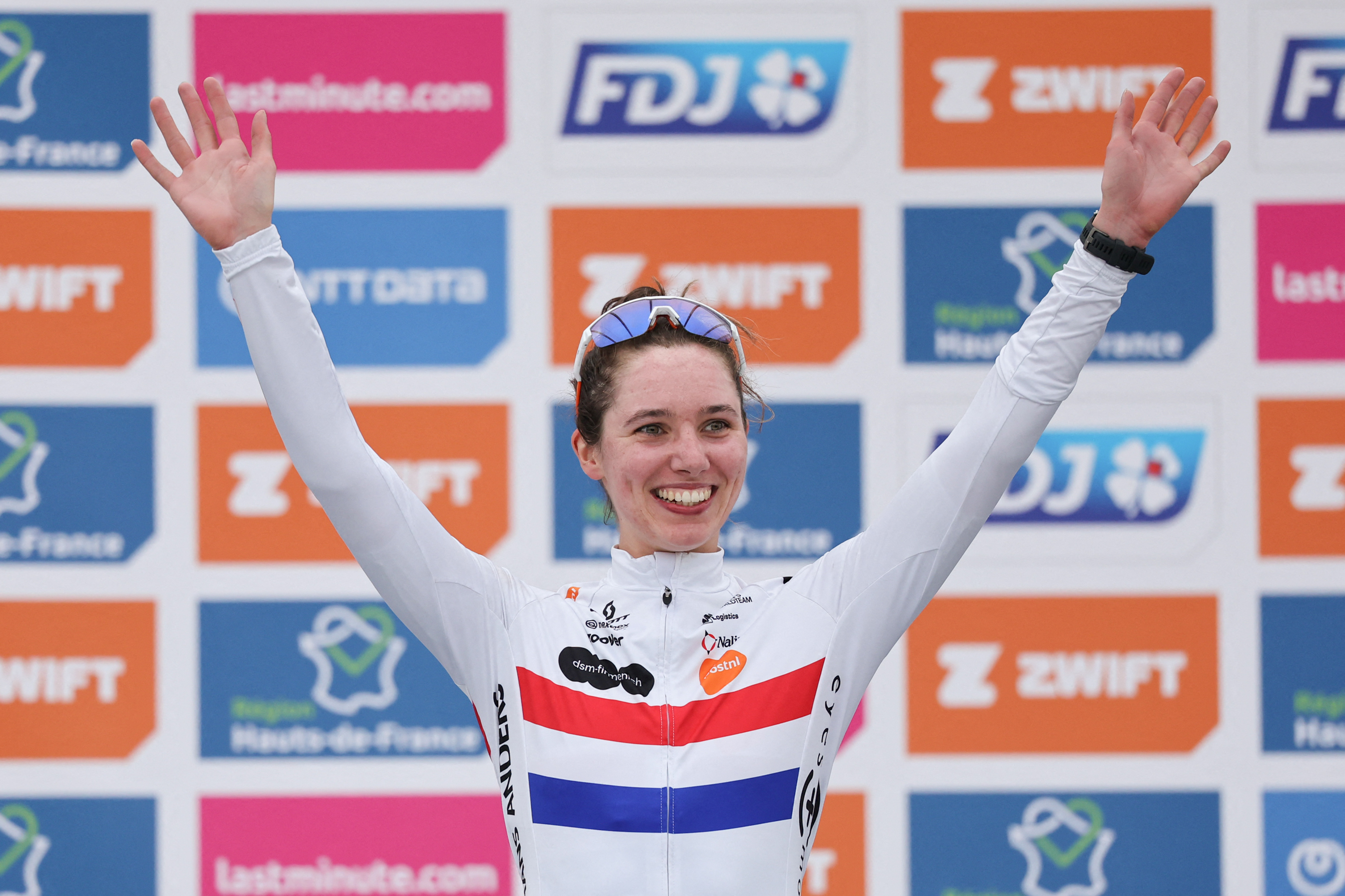 Team DSM-Firmenich PostNL's British rider Pfeiffer Georgi celebrates on the podium after placing third in the fourth edition of the women's Paris-Roubaix one-day classic cycling race, 148,5km between Denain and Roubaix, on April 6, 2024. (Photo by Francois LO PRESTI / AFP) / â€œThe erroneous mention[s] appearing in the metadata of this photo by Francois LO PRESTI has been modified in AFP systems in the following manner: [placing third] instead of [placing second]. Please immediately remove the erroneous mention[s] from all your online services and delete it (them) from your servers. If you have been authorized by AFP to distribute it (them) to third parties, please ensure that the same actions are carried out by them. Failure to promptly comply with these instructions will entail liability on your part for any continued or post notification usage. Therefore we thank you very much for all your attention and prompt action. We are sorry for the inconvenience this notification may cause and remain at your disposal for any further information you may require.â€