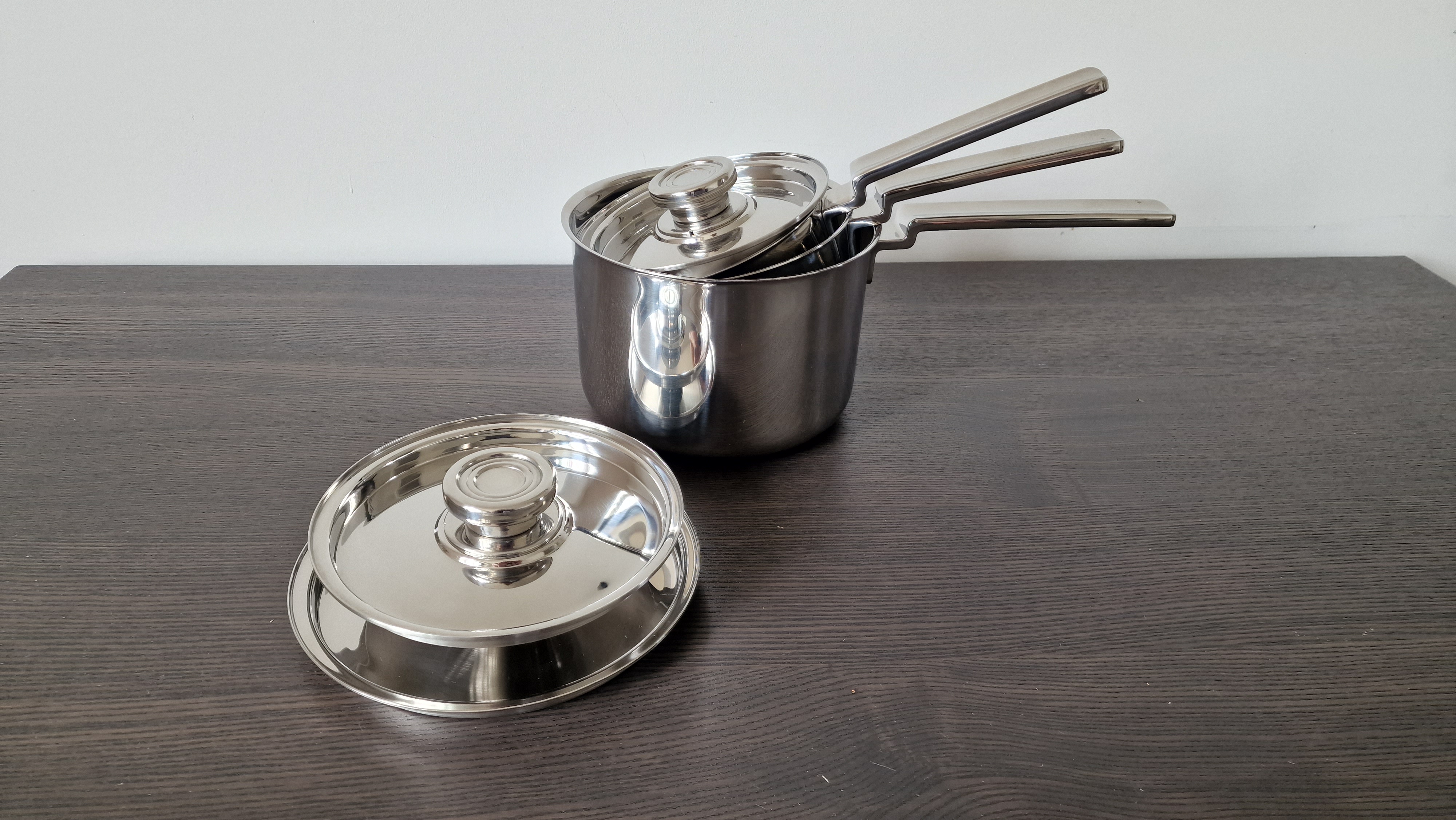 testing saucepan sets on a wooden table