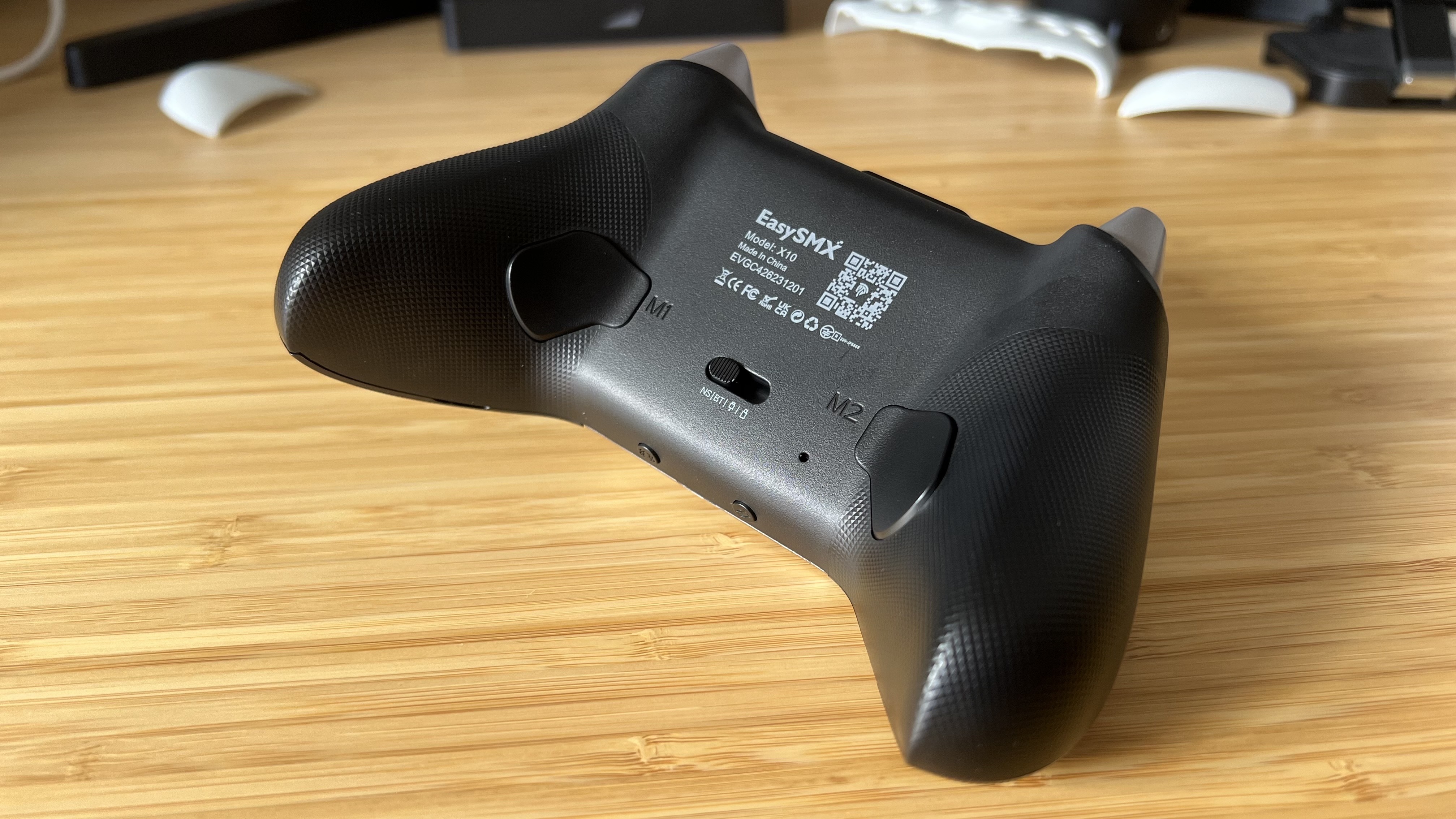 Back of EasySMX X10 controller on a wooden table
