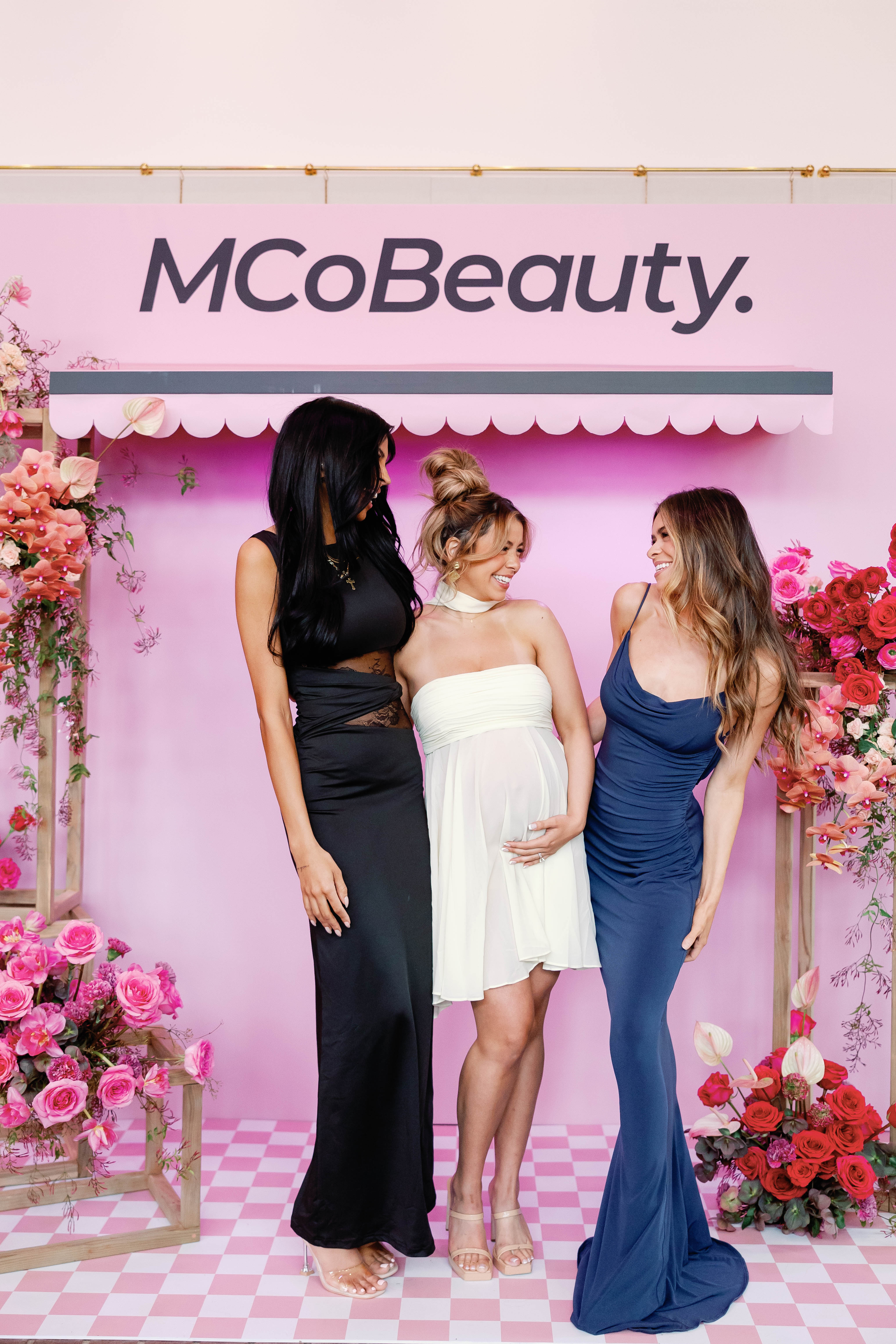a group of mormon wives season 2 castmembers laughing at a beauty event