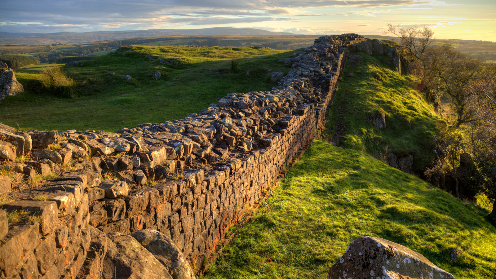 A stretch of Hadrian's Wall at Walton's Crags in Northumberland, England, coloured by the setting sun.