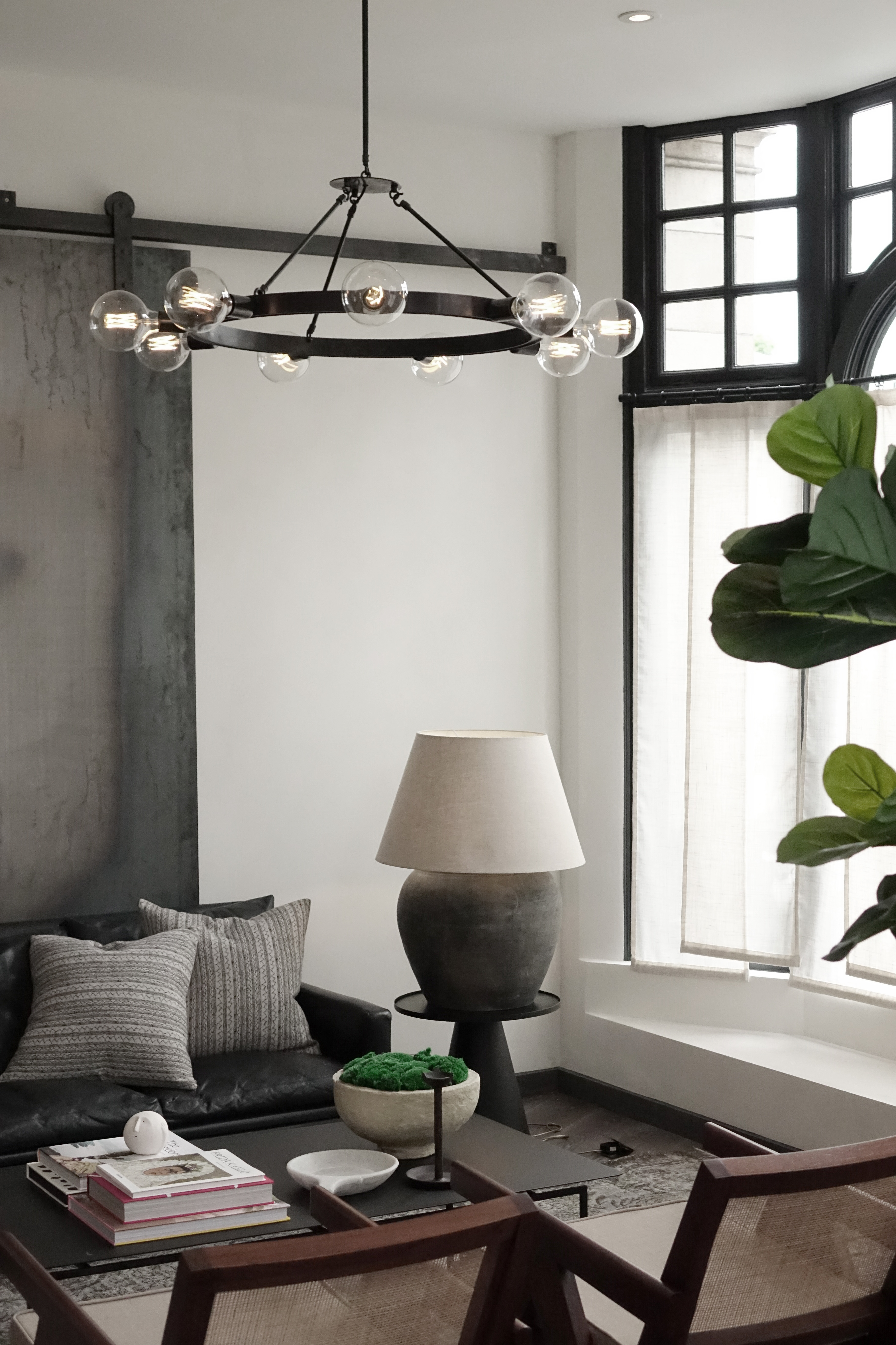 living room with white walls and large round pendant light