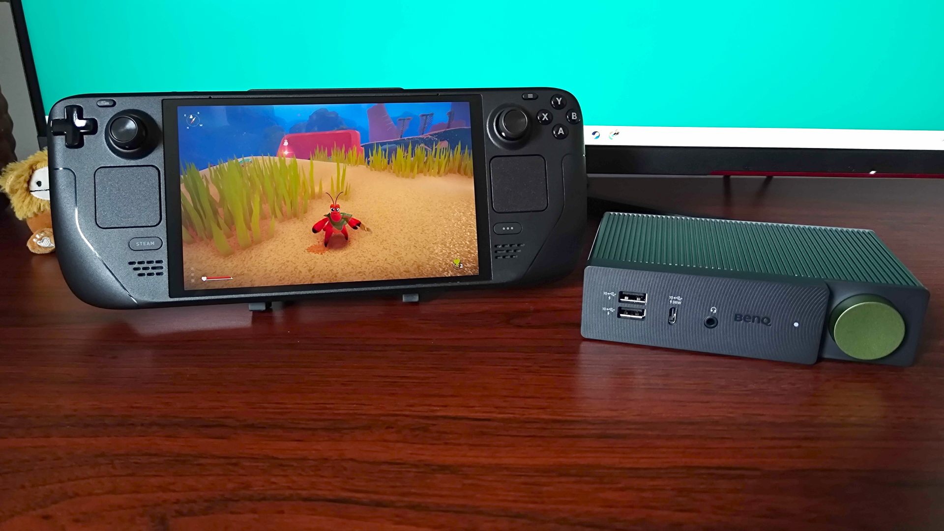 BenQ BeCreatus sitting next to Steam Deck with Another Crab's Treasure gameplay on screen