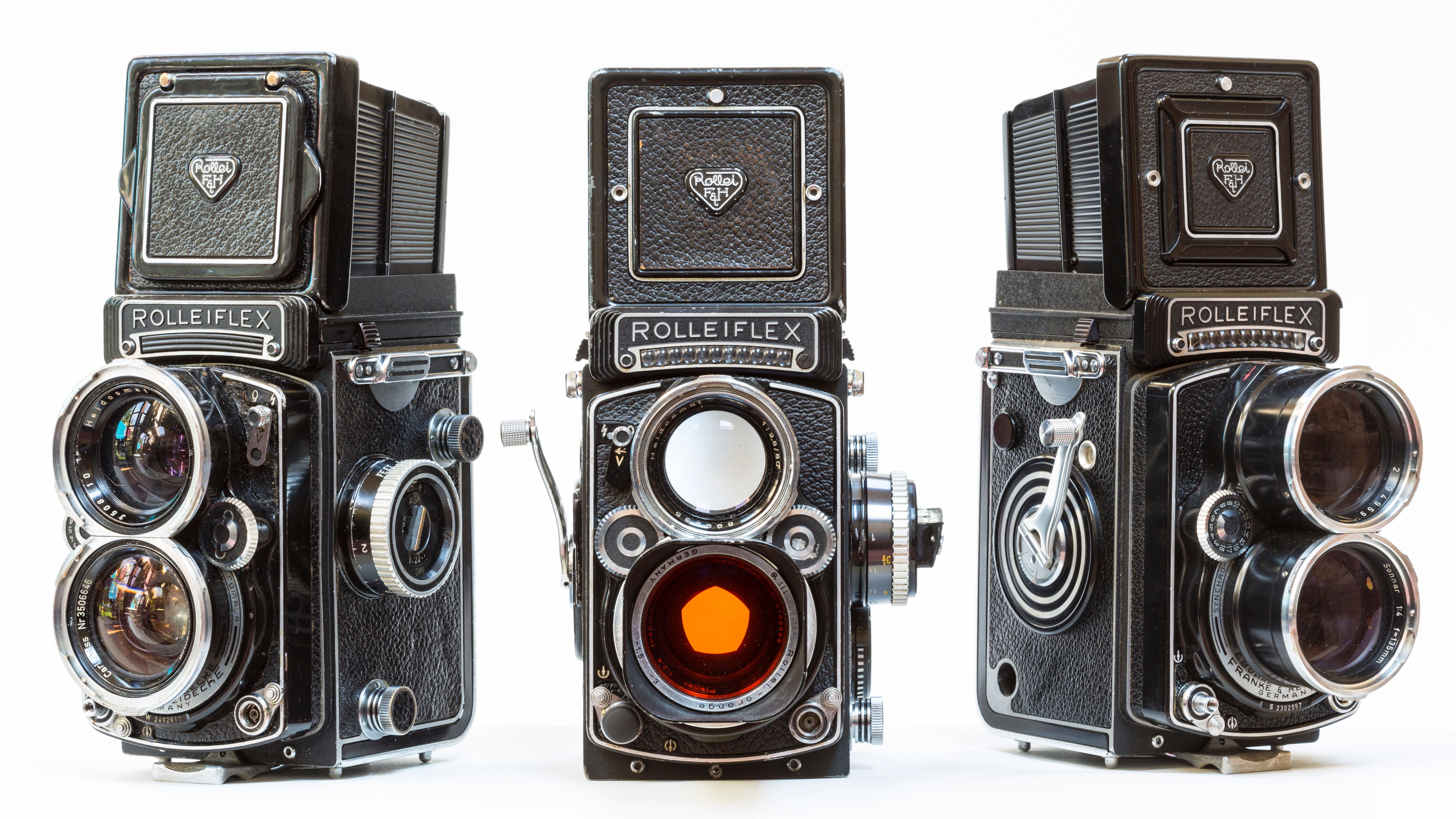 A trio of 1960s Rolleiflex professonal photographers film cameras used in the 1960&#039;s. L-R Rollei Wide, RolleiTLR 2.8F and a Tele Rollei.