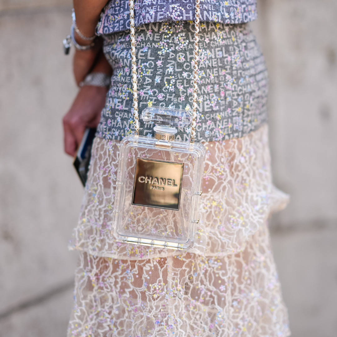 Woman wearing classic perfume bag Chanel No5 bottle handbag