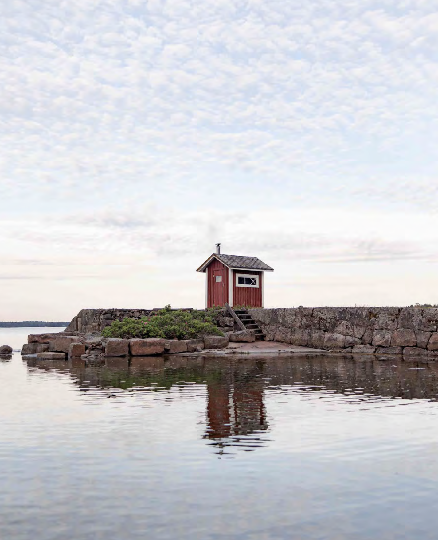 red sauna by rocky beach