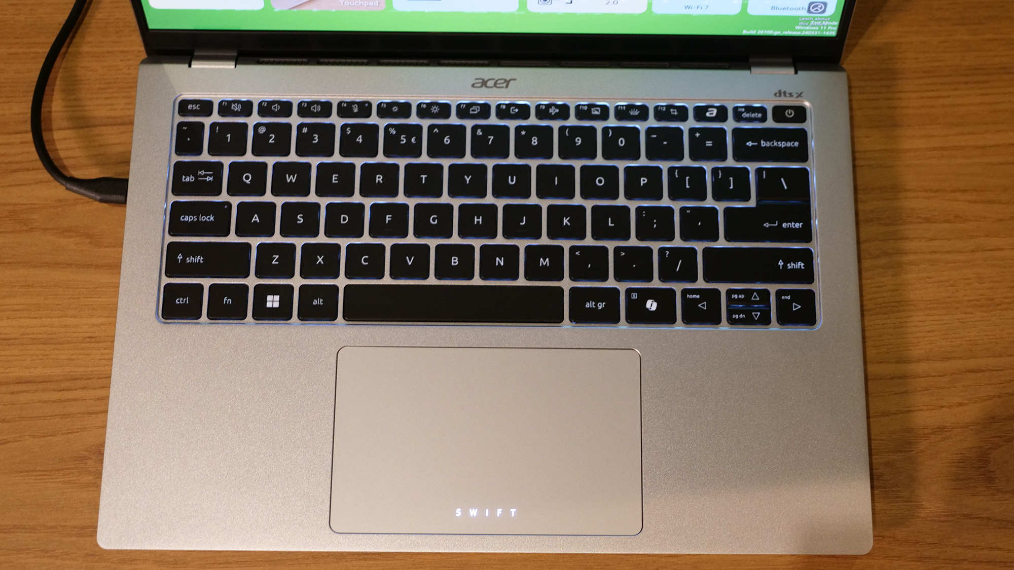 Acer Swift 14 Go (2025) on a wooden tabletop.