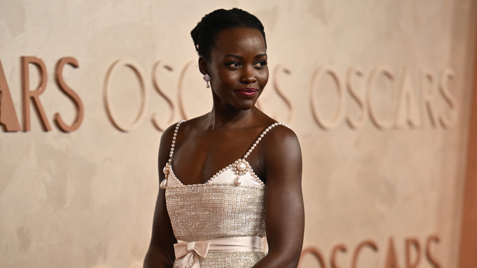 Lupita Nyong'o on the 2025 Oscars red carpet wearing custom Chanel