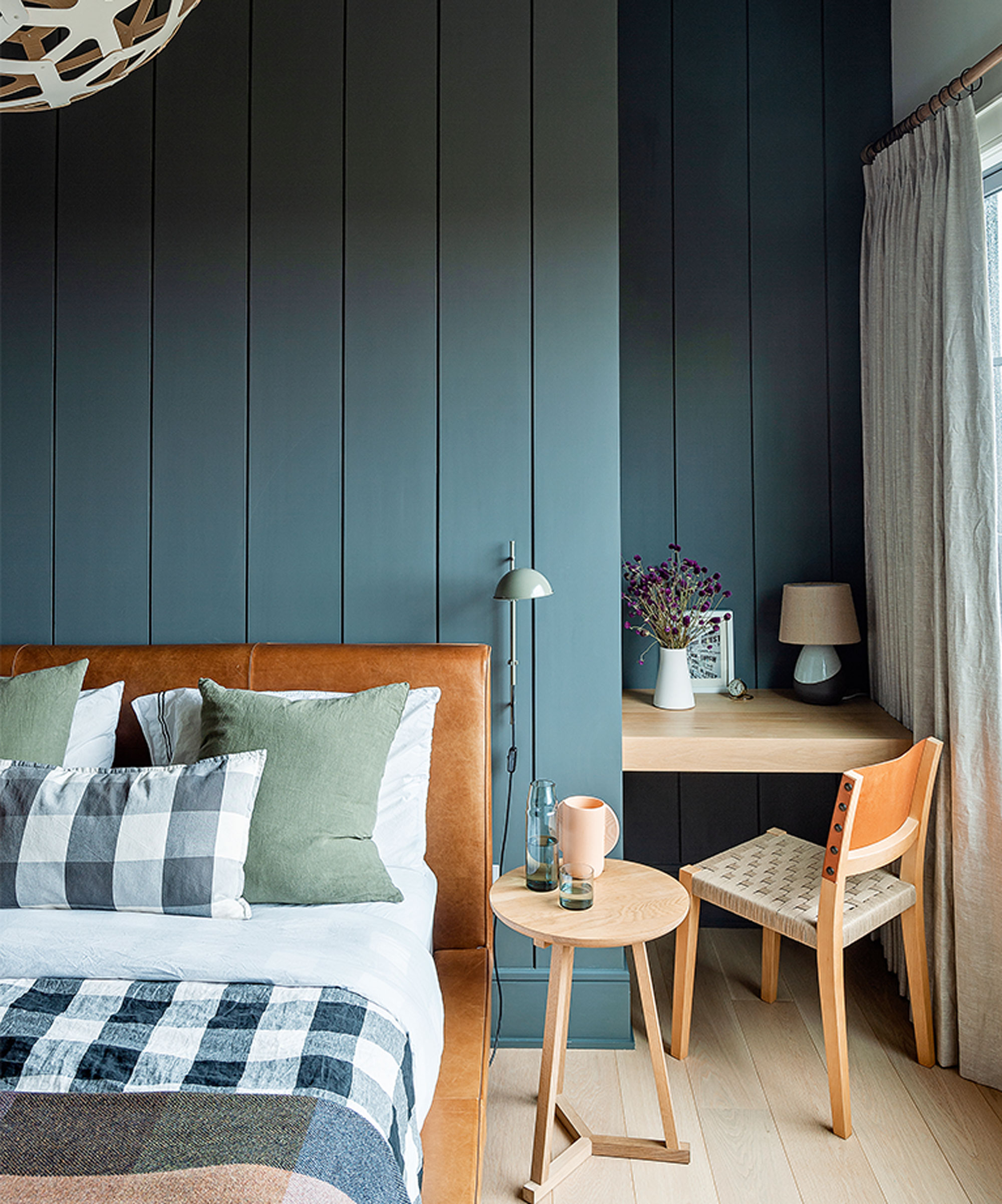 green panelled bedroom with alcove desk and chair