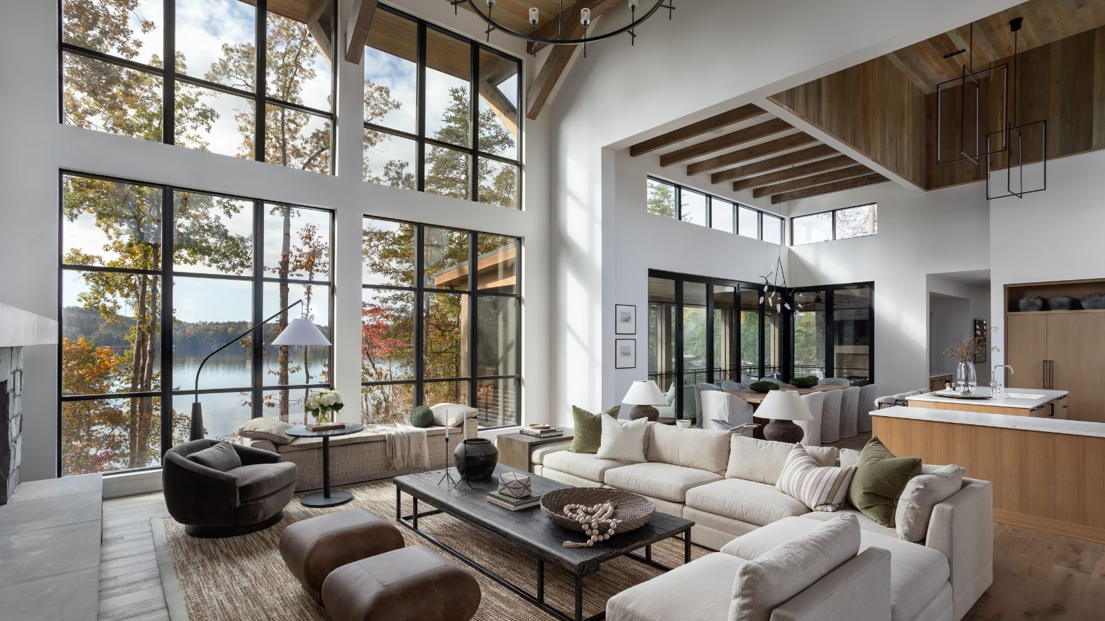lakeside living room with wooden ceiling, floor and kitchen