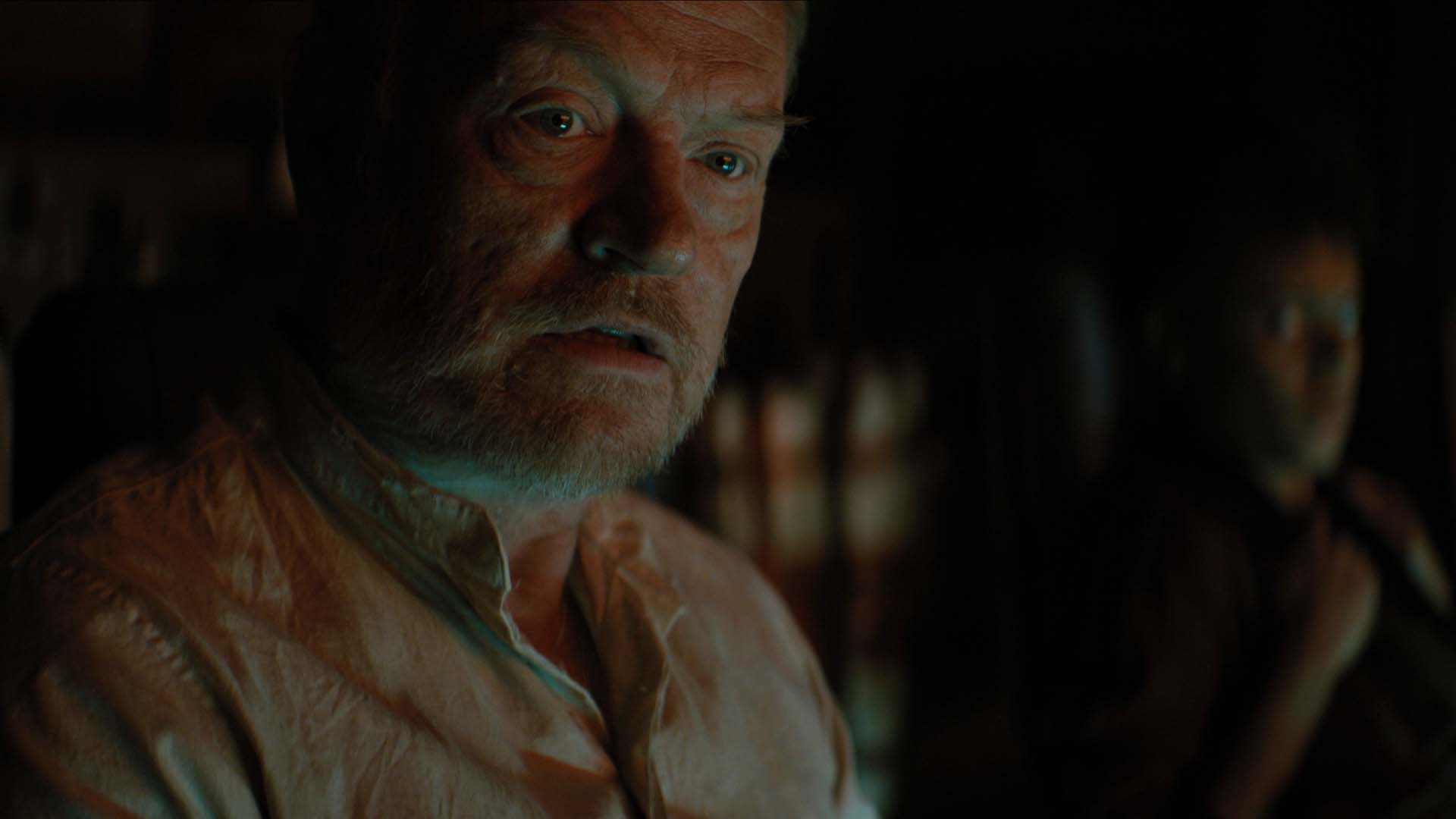 A close up of a concerned Hari Seldon sitting down in Foundation season 2