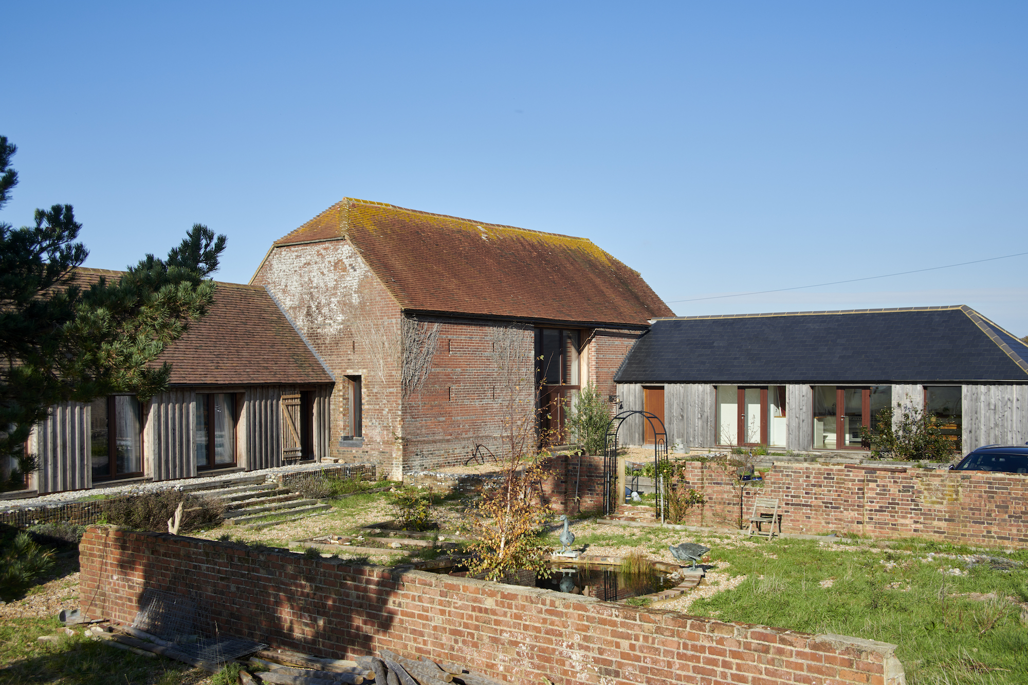 large barn with wild garden to front