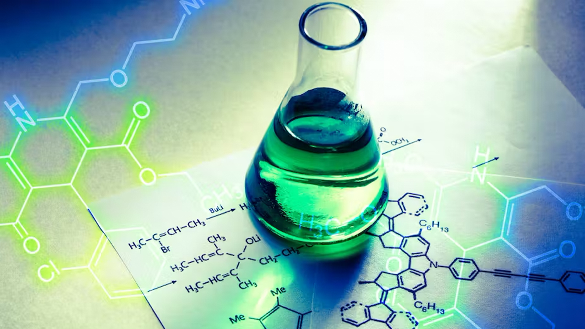 Chemistry beaker with green liquid atop chemical notes.