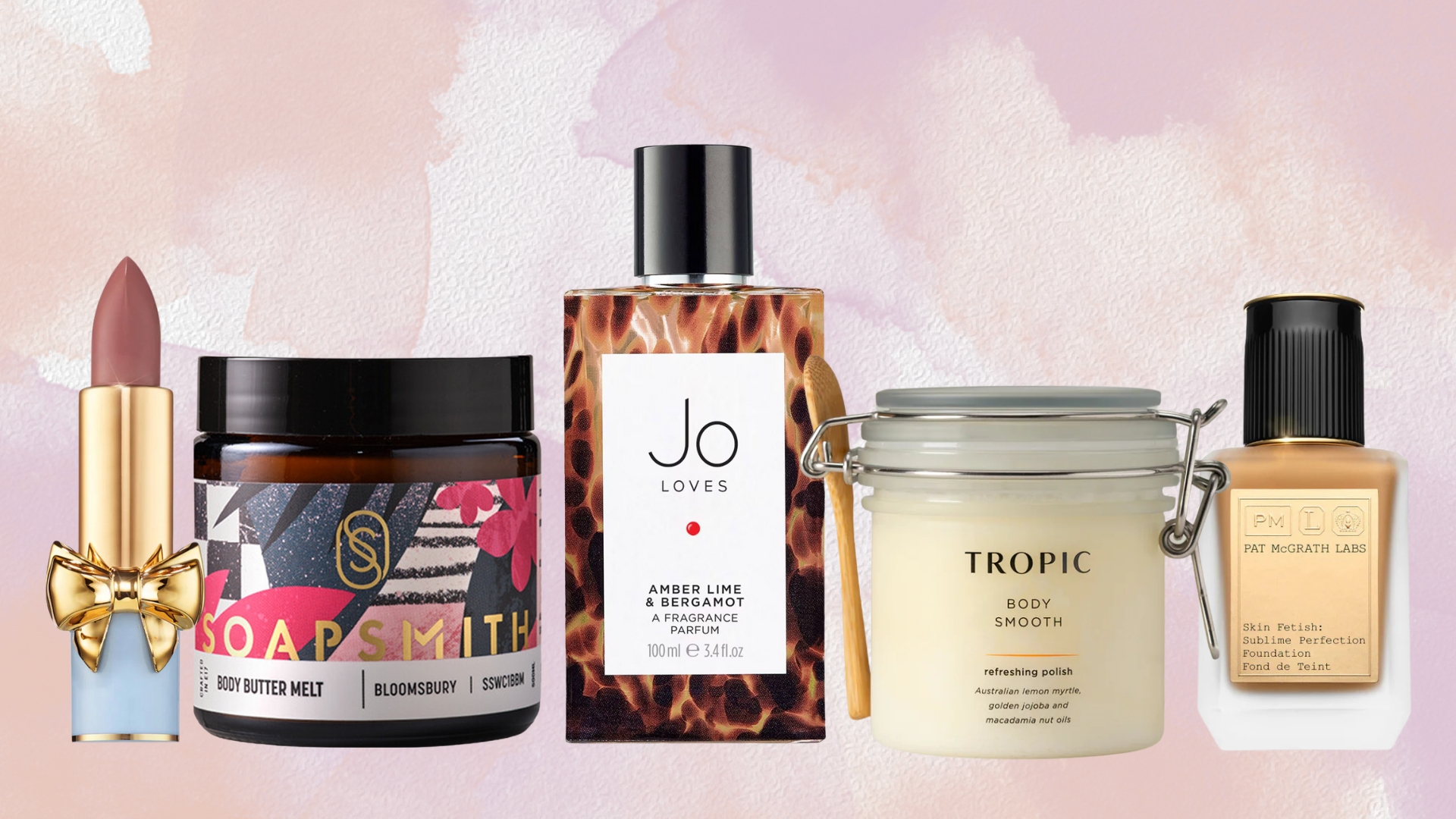 A collage of products from our team&#039;s favourite woman-owned beauty brands (L-R) Pat McGrath lipstick, SoapSmith Body Butter, Jo Loves Fragrance, Tropic Skincare Body Scrub and Pat McGrath Foundation, on a pink and purple watercolour background