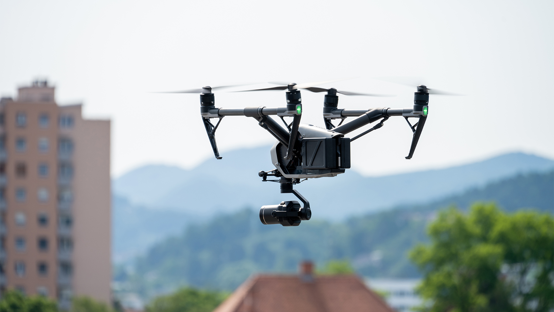 View of drone with camera flying over city.