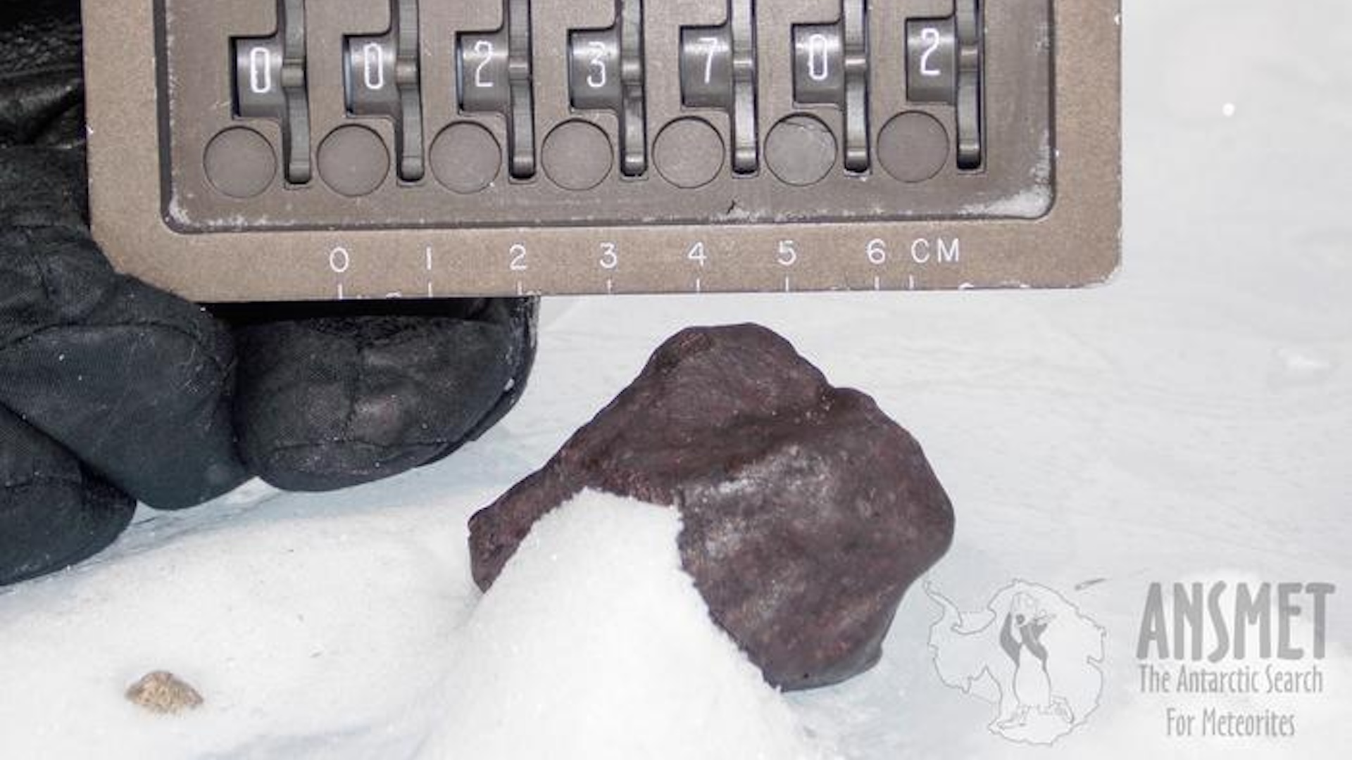 a closeup of a meteorite in the snow