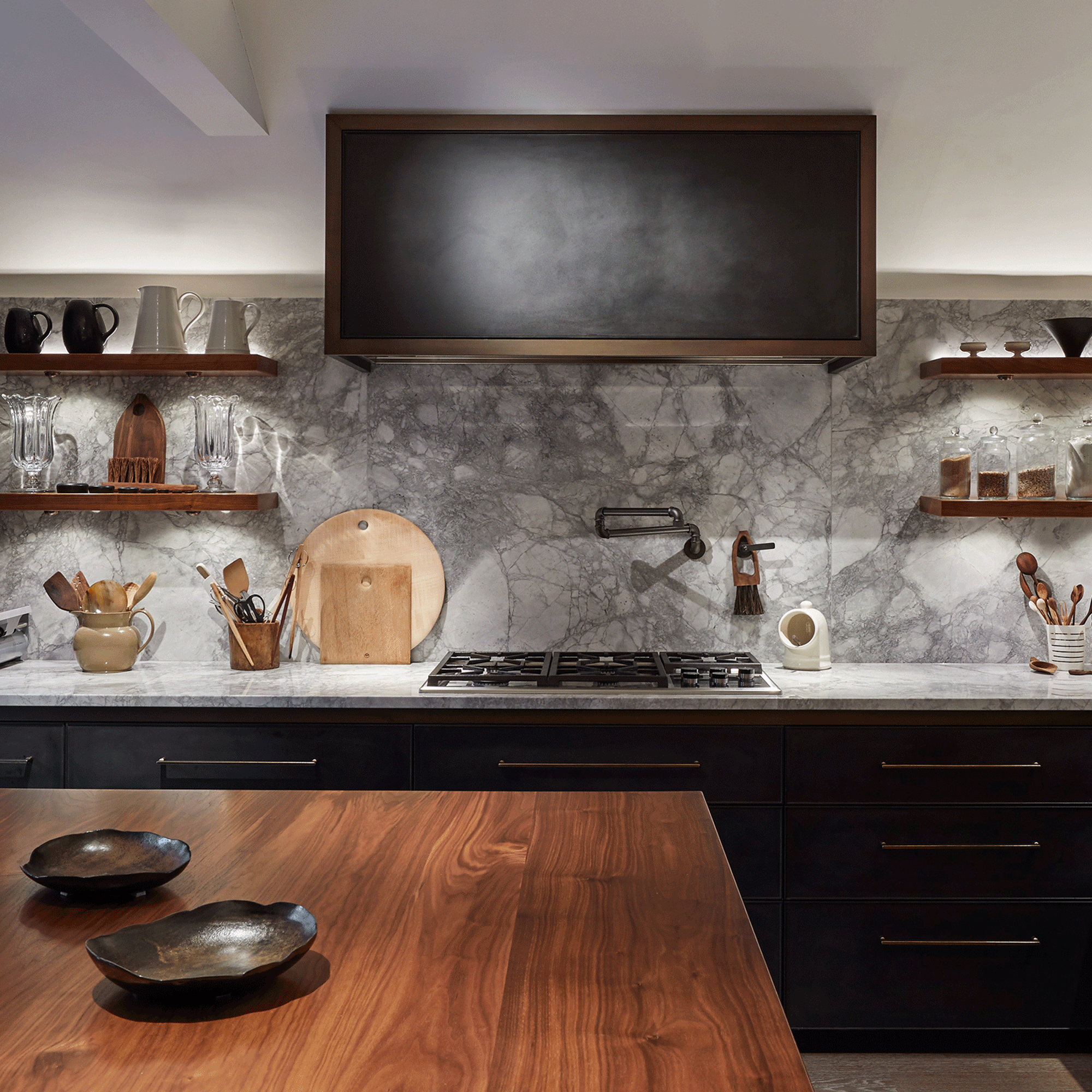 Kitchen with concealed lighting shining on marble splashback