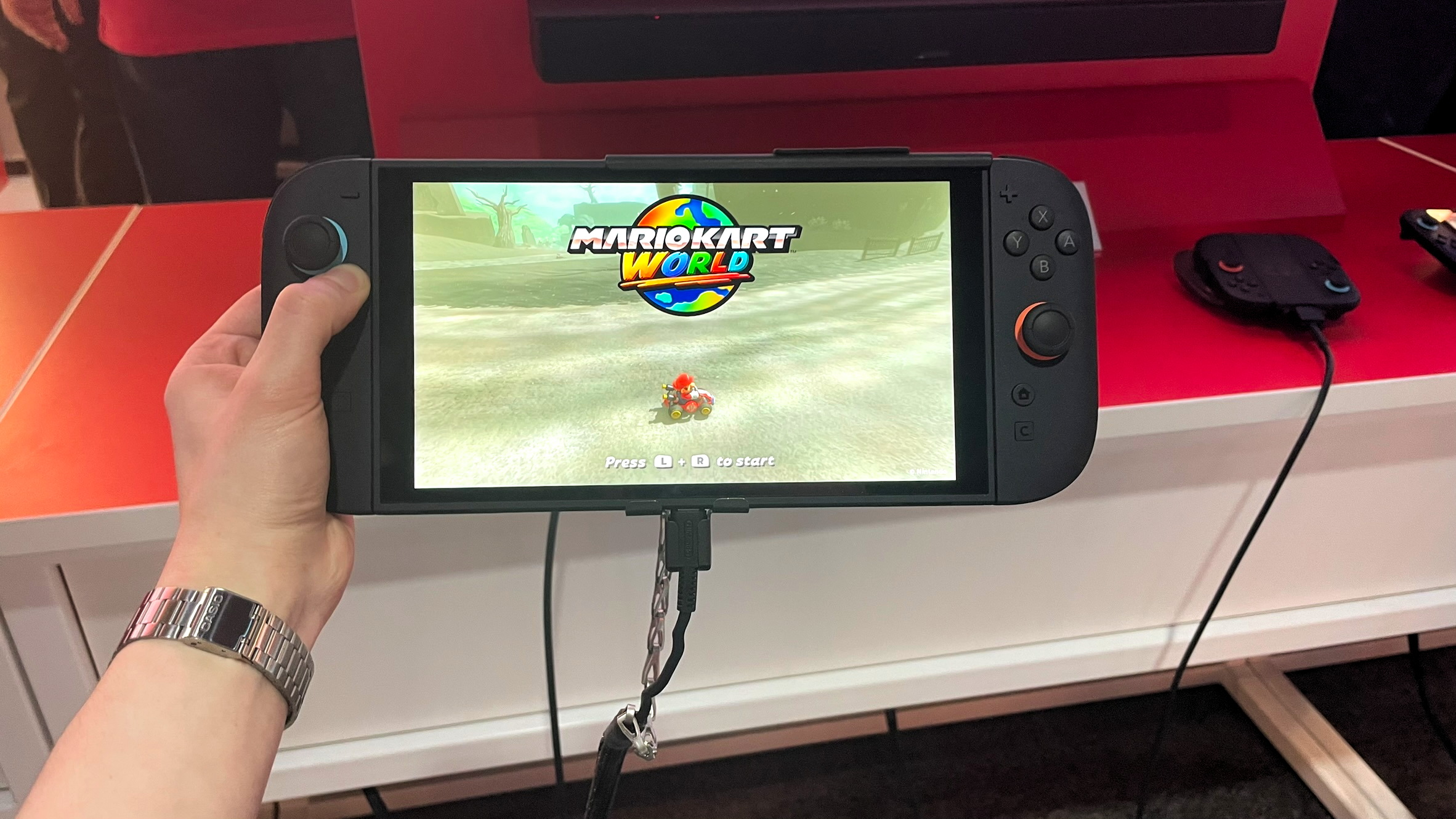 A hand holding the Switch 2 in handheld mode while running Mario Kart World at the Switch 2 NYC preview event on April 4, 2025