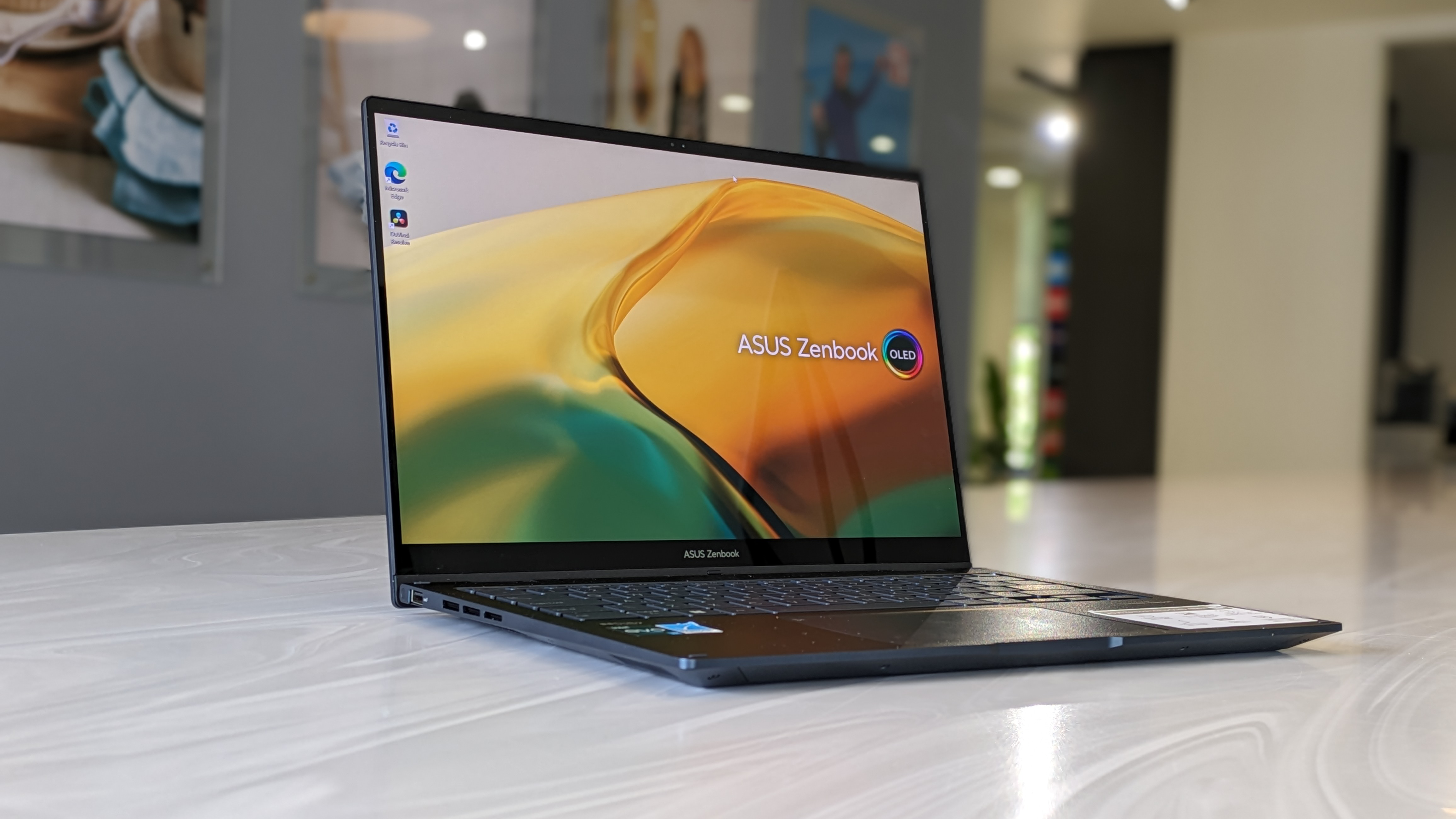 The Asus Zenbook 14 Flip OLED on a white surface