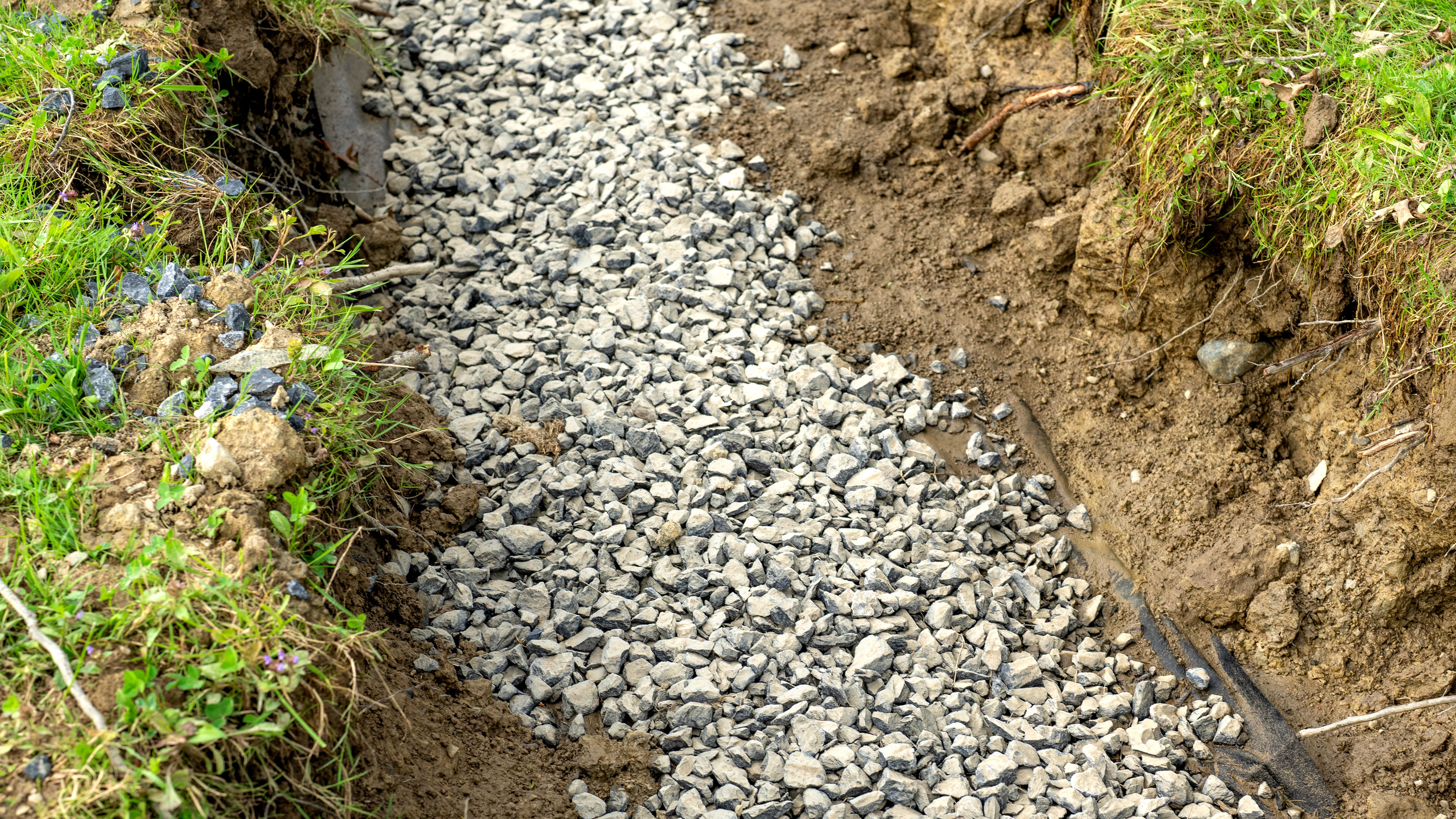 Finished French drain trench ready for covering
