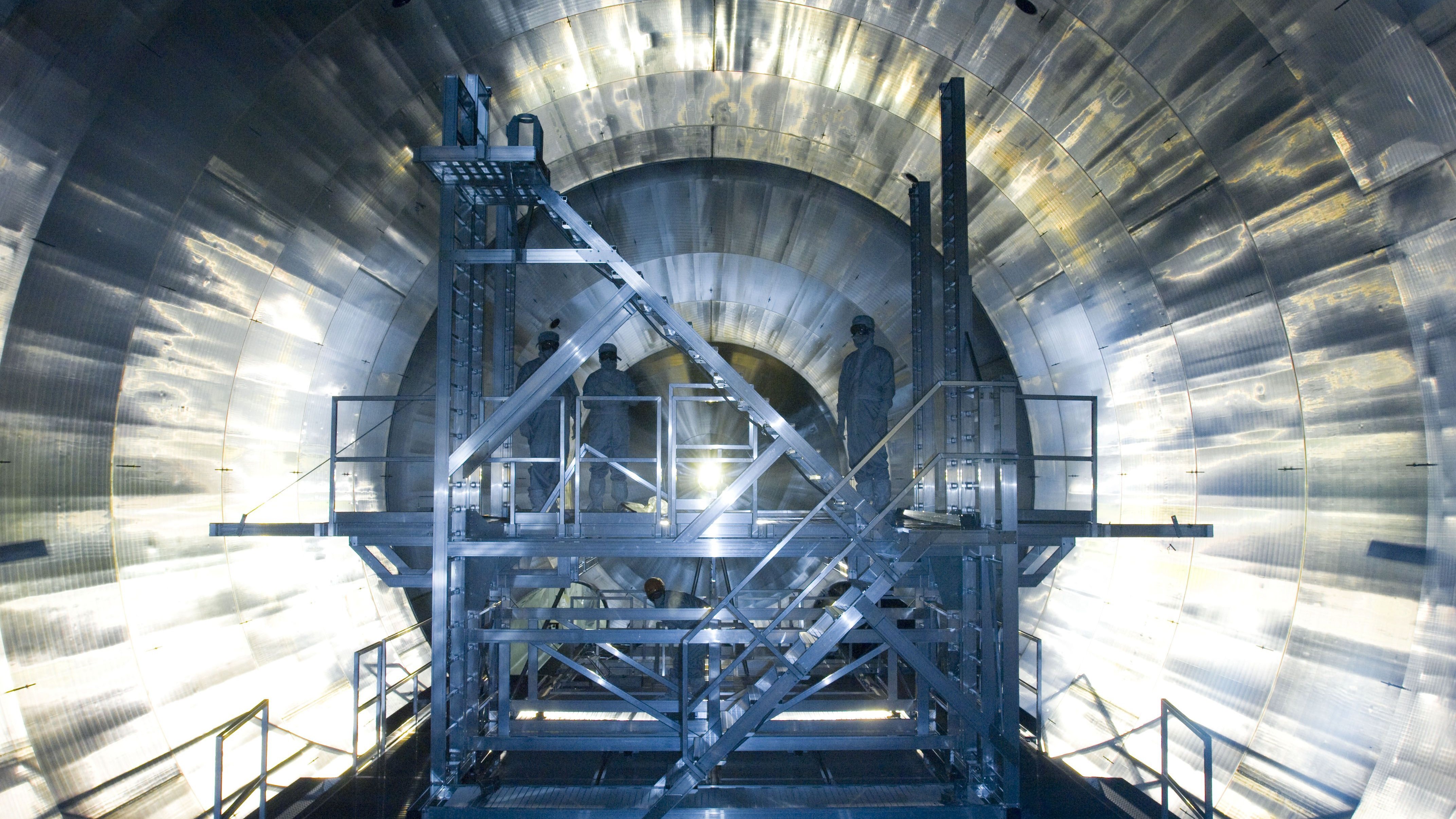 Engineer stand inside the KATRIN neutrino experiment at the Karlsruhe Institute of Technology in Germany.