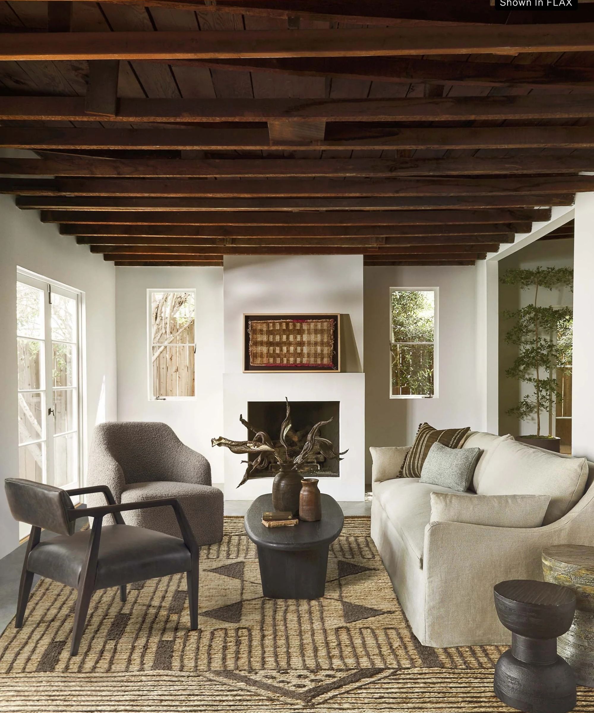 White living room with wooden beams and cream slipcovered sofa