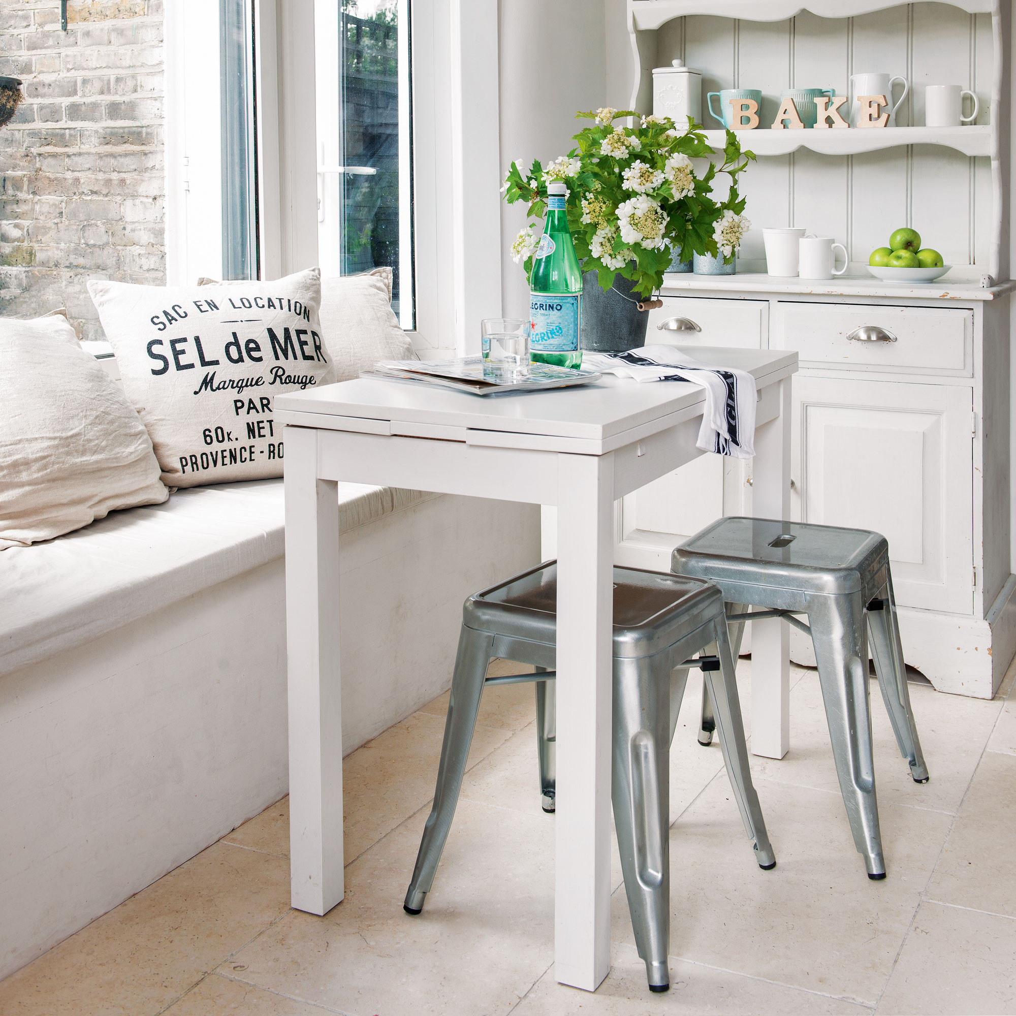 kitchen room with wooden flooring and table with stools