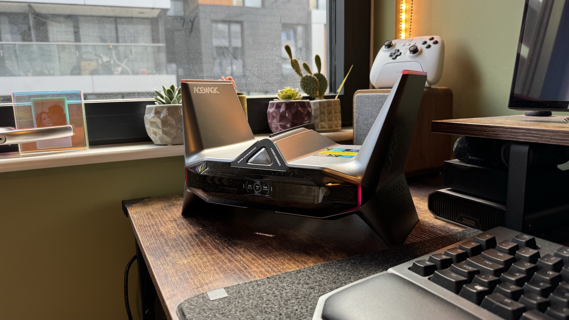 Acemagic M2A Starship mini gaming PC on a desk, showing its ports and unusual design on a wooden desk