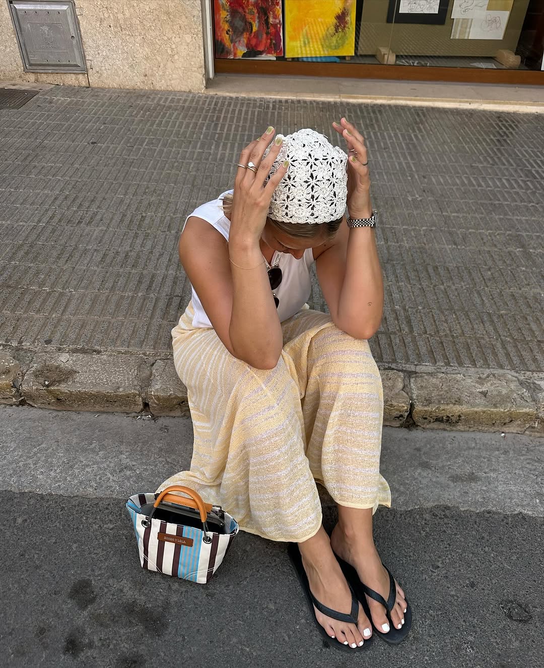 woman wearing yellow pants and black flip flops