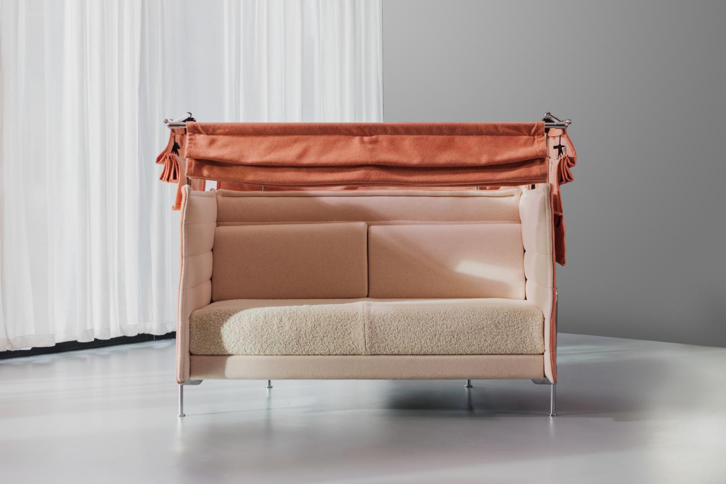 A two-seater 'Alcove' sofa in pale pink and orange tones.