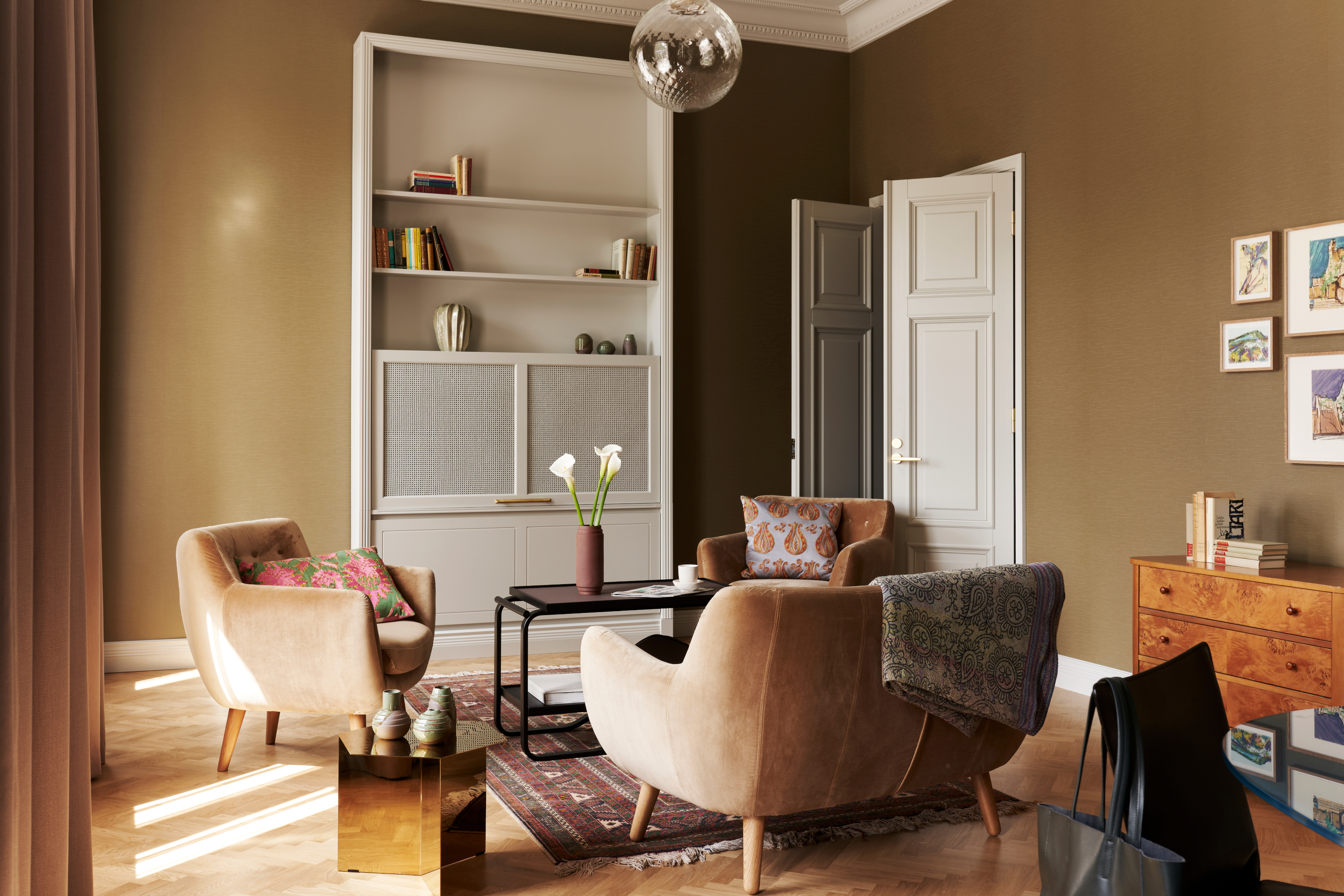 hotel suite at st george hotel in helsinki, sofas and chairs in green walled room