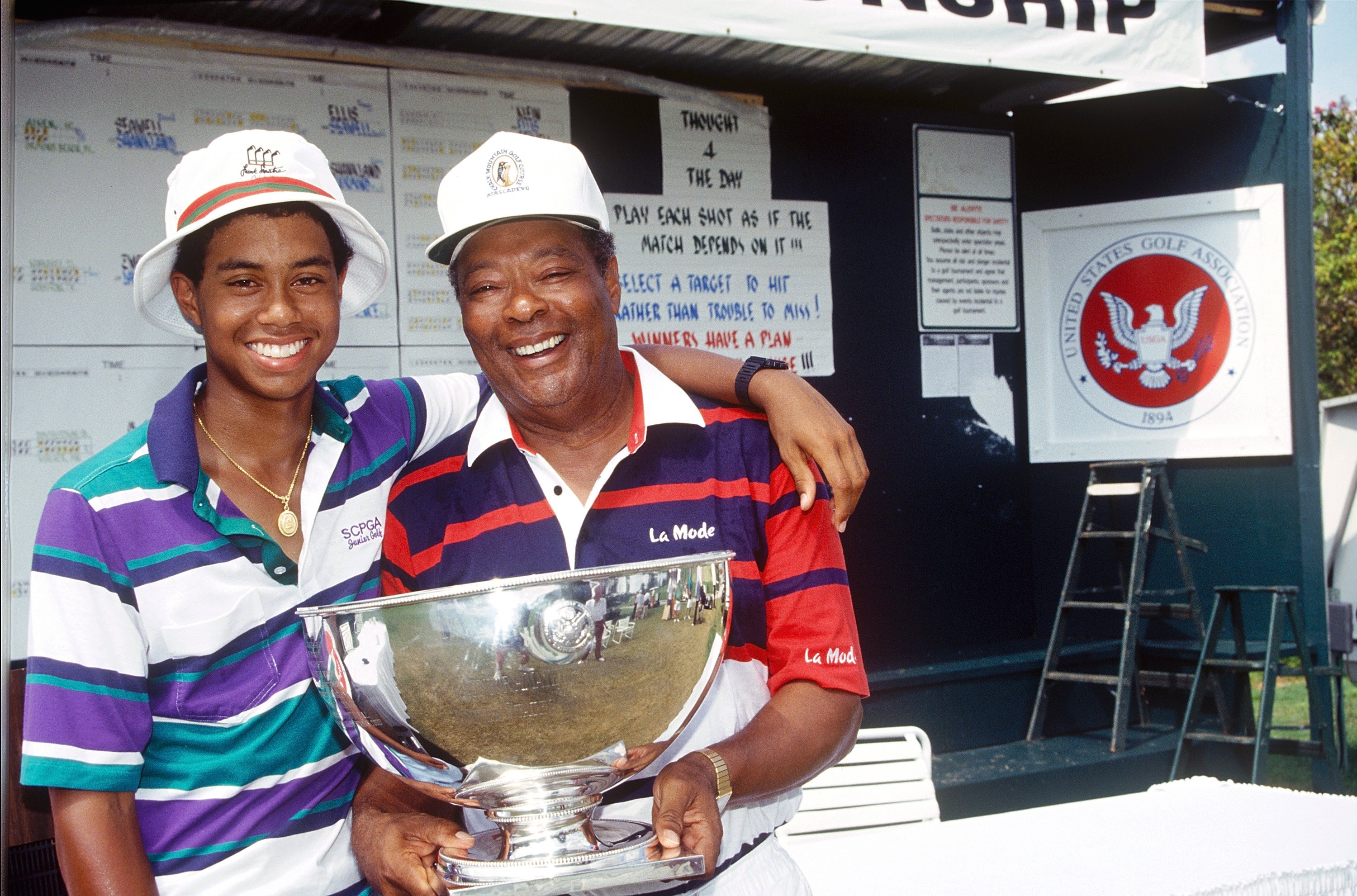 Tiger and Earl Woods hold a trophy