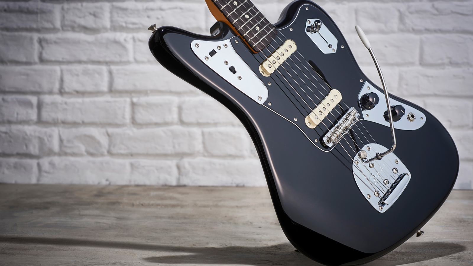 Fender Jaguar against white brick wall
