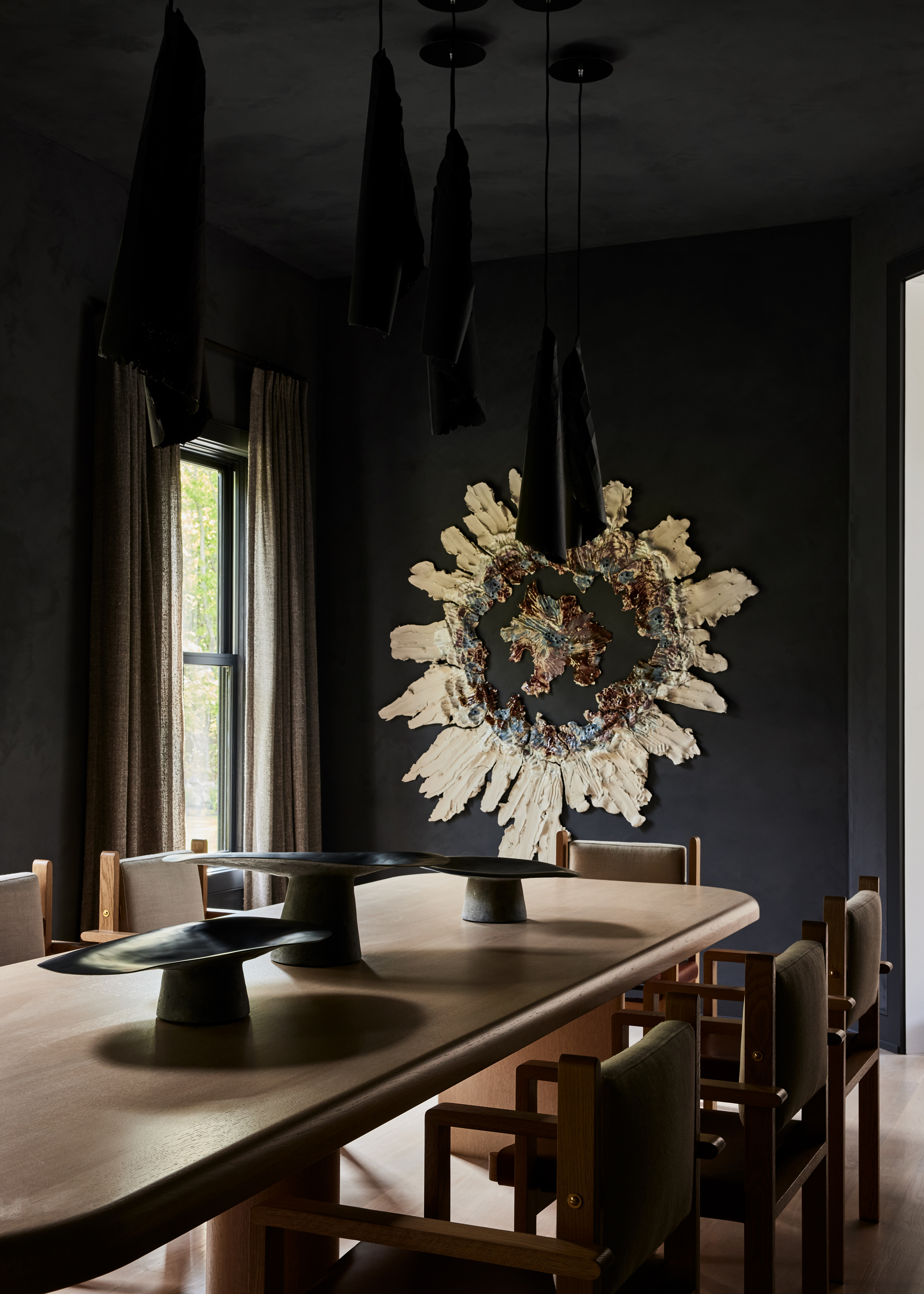 A dining room with dark, moody elements of decor