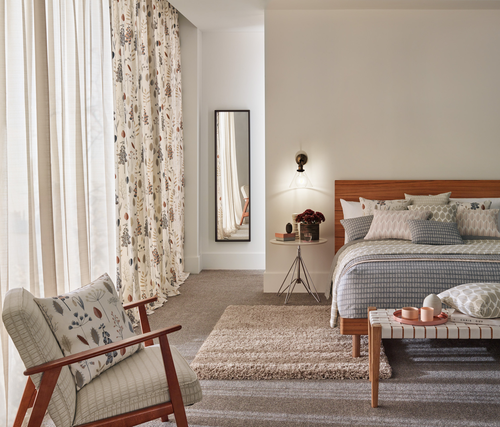 bedroom with sheer drapes and floral curtains
