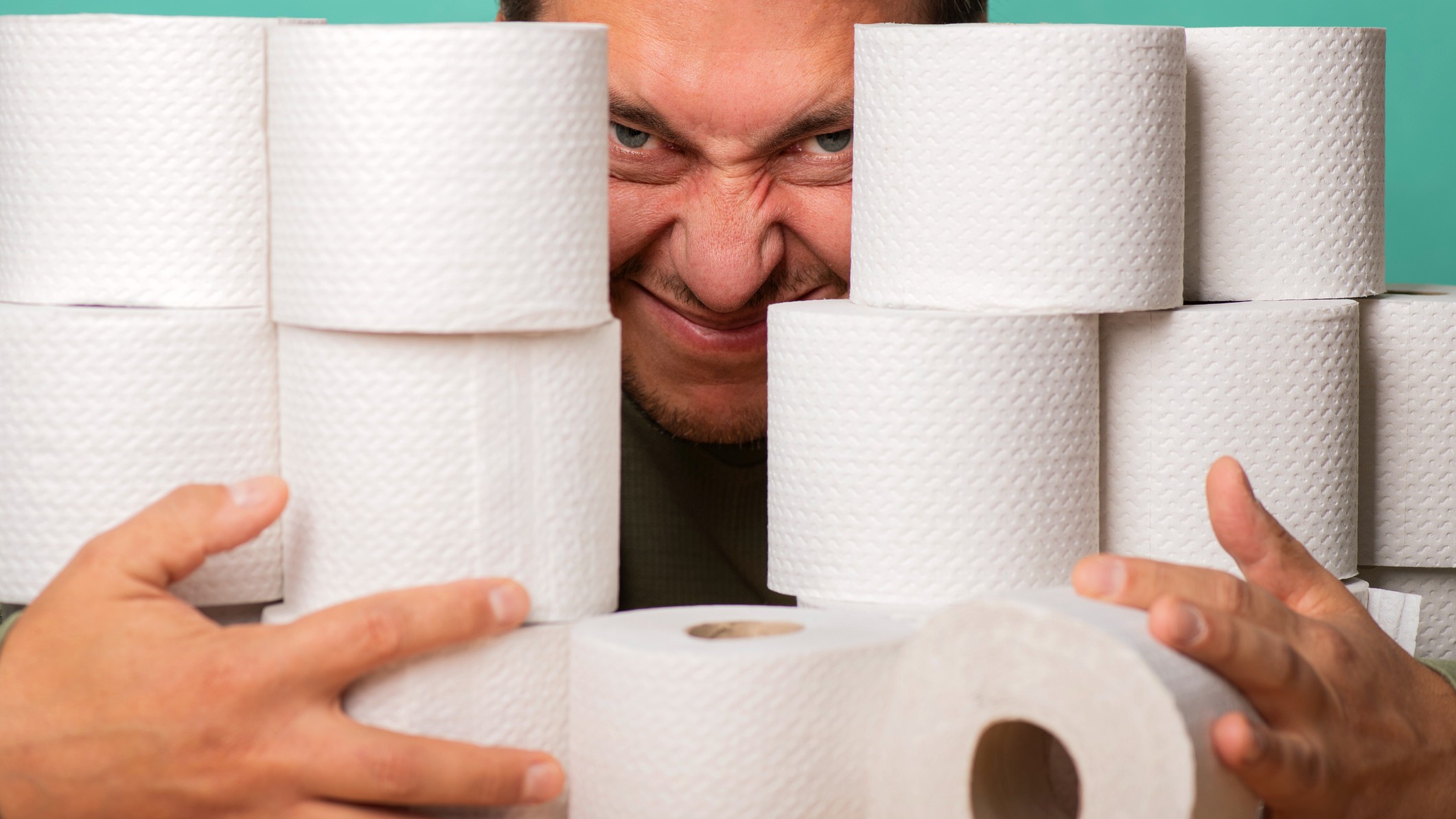 Greedy man with lots of toilet rolls