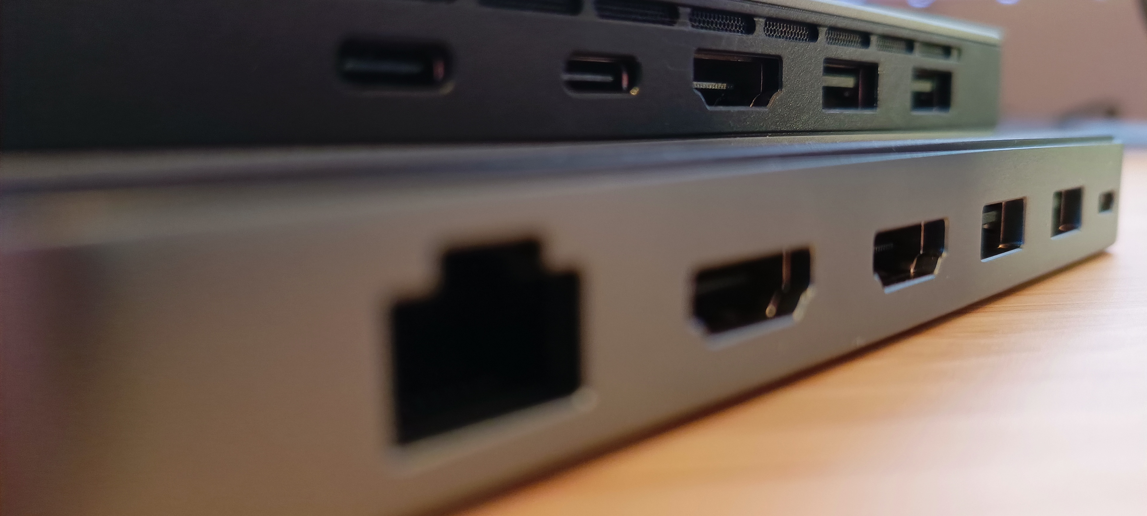 A silver Khadas Mind mini PC sitting on a wooden desk