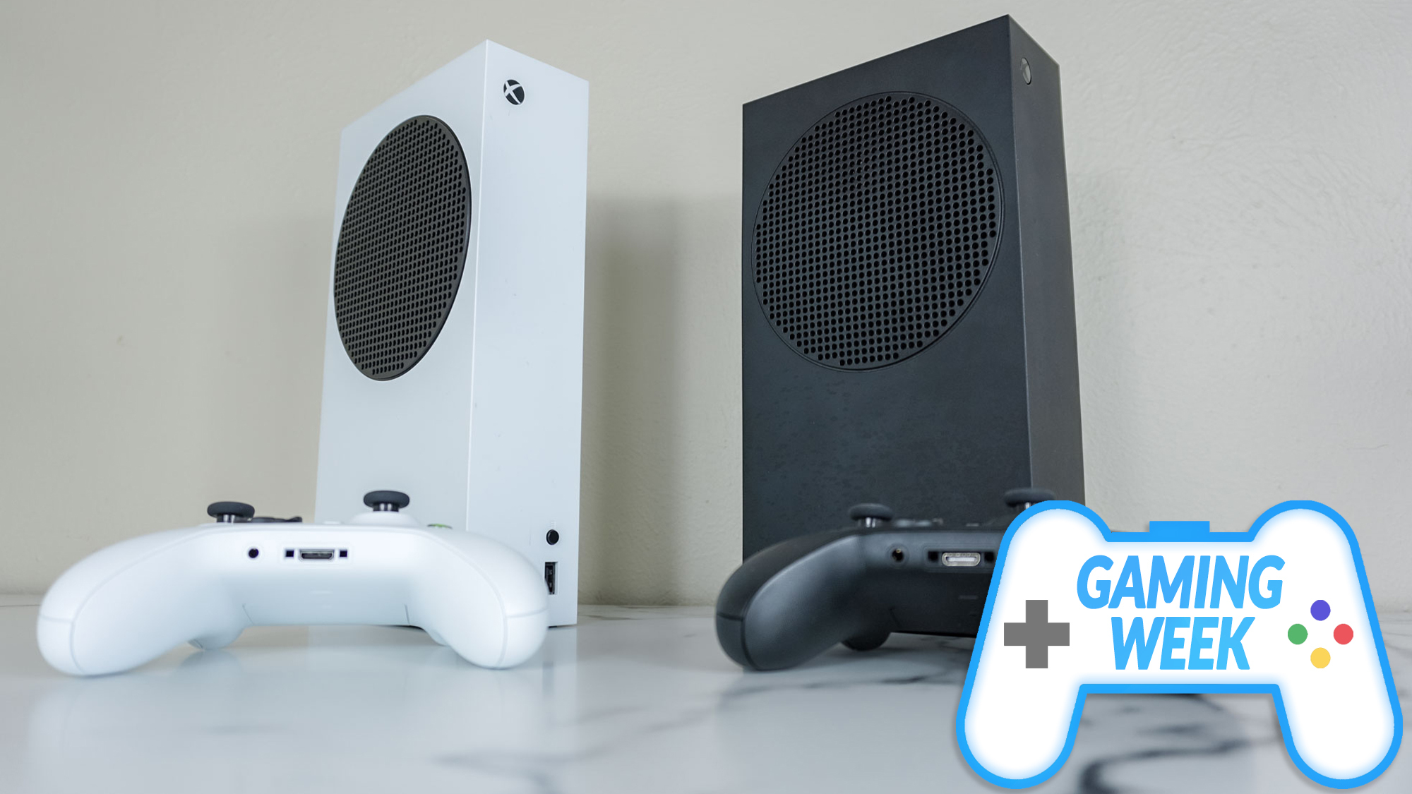 The white and black Xbox Series S consoles next to each other on a desk with a Tom's Guide Gaming Week badge in the lower right corner