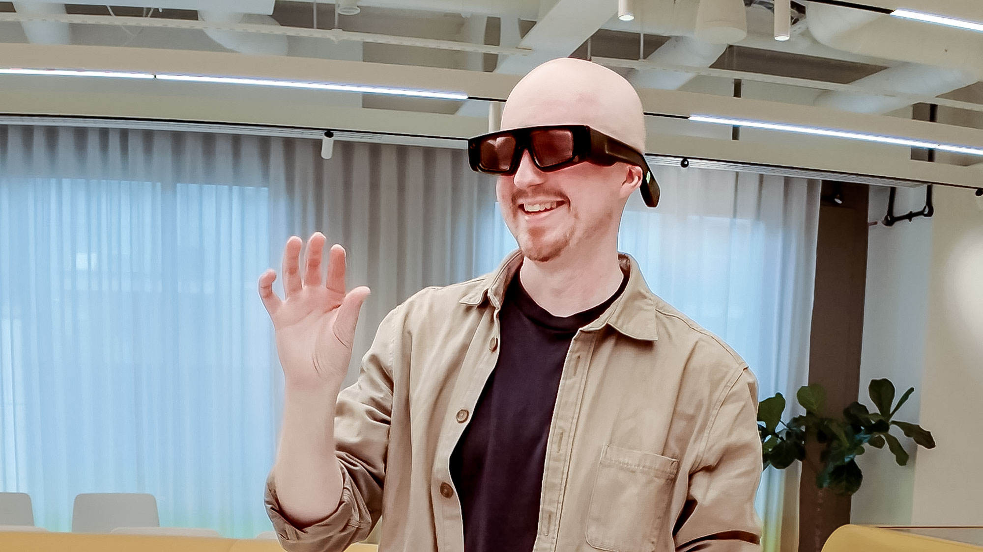 Snapchat Spectacles being worn on person playing around with others in an office space