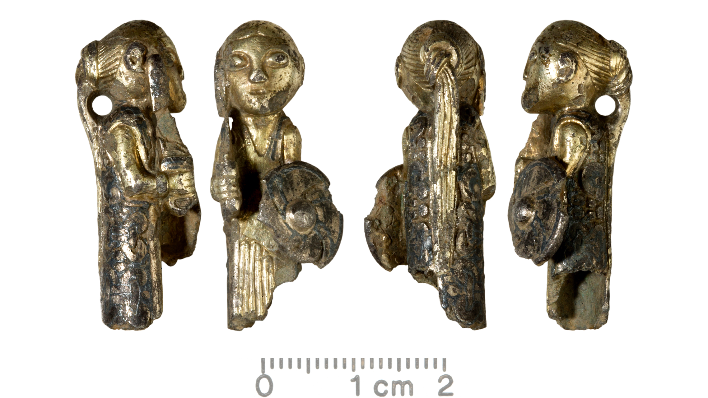 Four views of a gold-covered figurine in the shape of a woman. She holds a shield and a sword and wears her hair in a ponytail. There is a small hole behind her neck, perhaps for hanging.