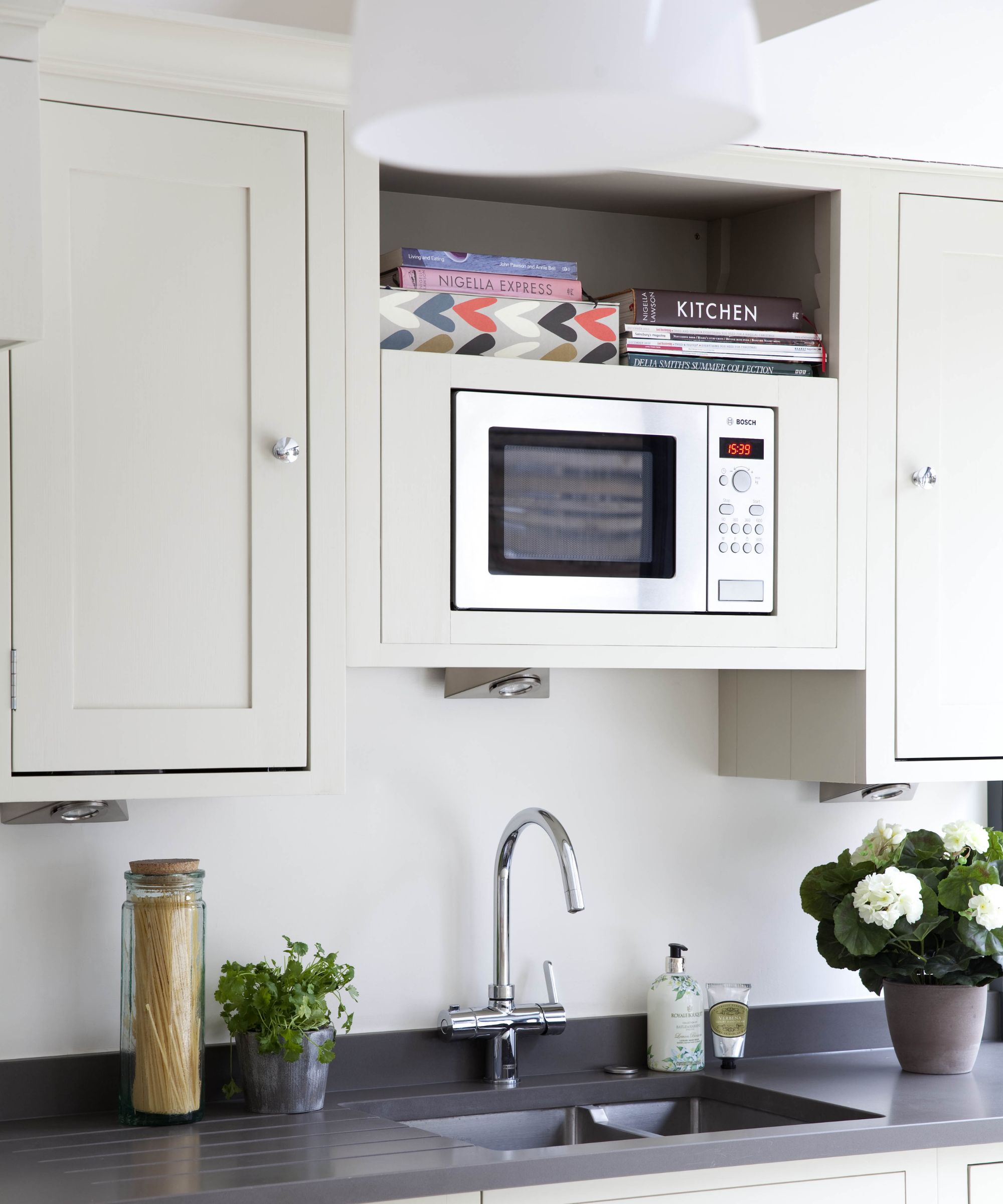 Kitchen with neutral cabinets, dark countertop and microwave